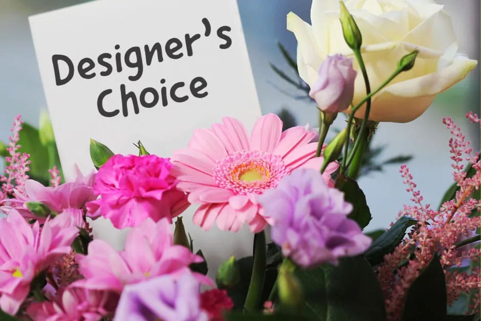 Mixed pink and white flower bouquet with a Designer's Choice sign