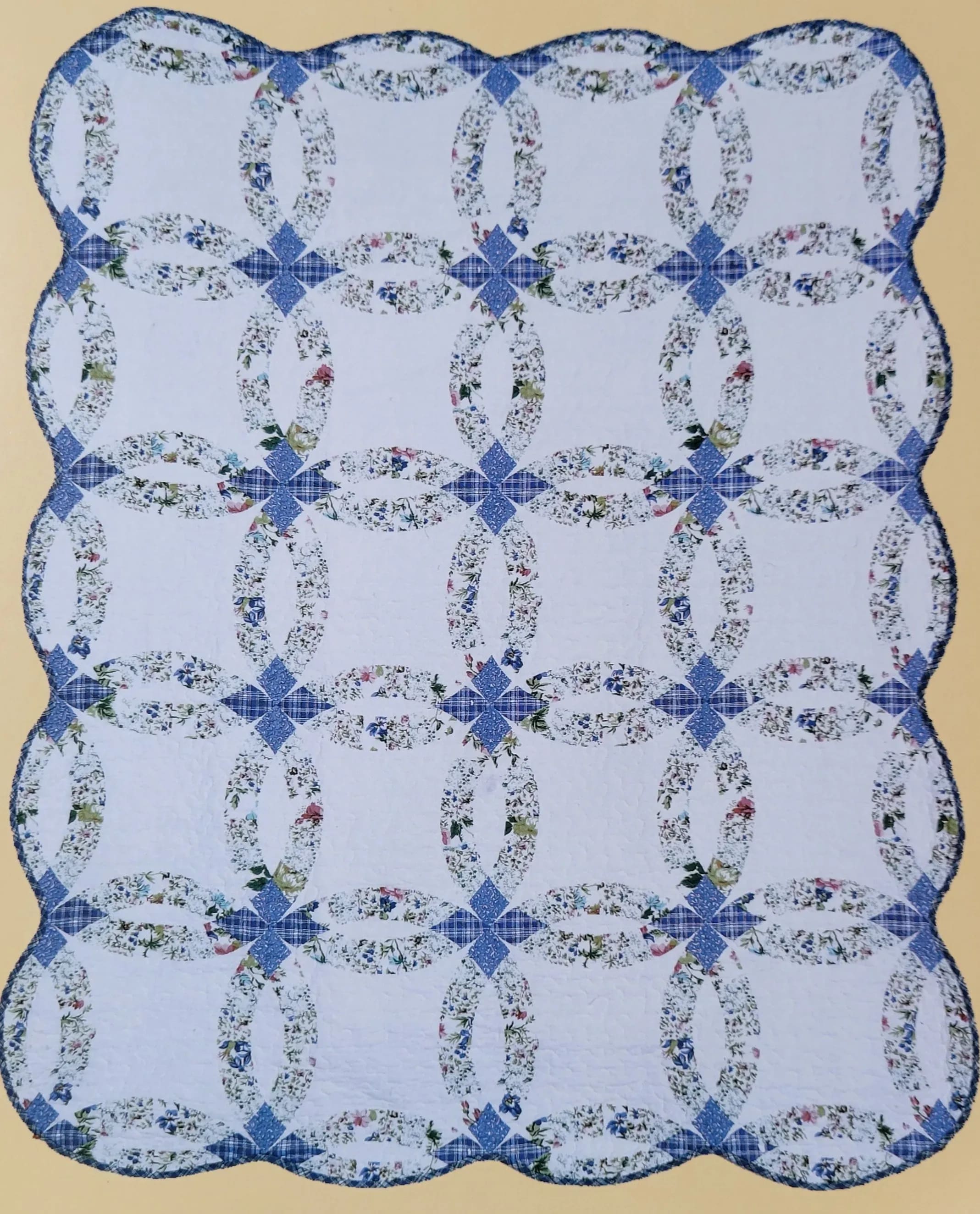 Blue and white quilt with floral ring patterns