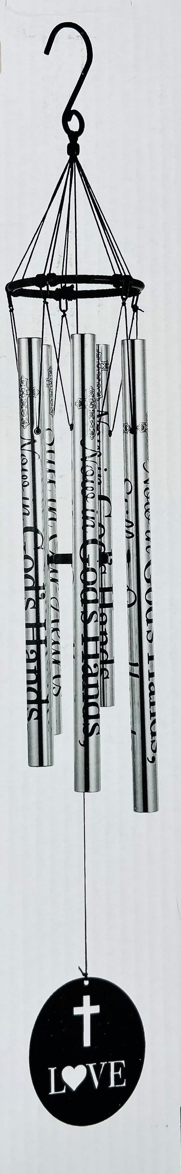 In God's Hands Wind Chime  - A solemn stainless steel wind chime engraved with "In God's Hands / Still in Our Hearts" offers a peaceful, devotional touch for sympathy and funeral tributes. This memorial wind chime and oval wind catcher - accented with a cross and the brief message "Love" - is designed to comfort the person you're honoring, giving mourners a gentle, audible reminder of memory and presence.  Crafted for resonance, the hand-tuned chimes produce clear, sustained tones and measure 37" from the top gathering ring to the bottom of the wind catcher (overall 5" x 37" height). The set pairs naturally with the simple black metal easel stand and the paired horizontal plaques shown, creating a refined presentation for a graveside, memorial service, or remembrance display. The stainless finish and monochrome palette keep the look formal and devotional rather than decorative.  Ideal for funeral services or as a thoughtful keepsake to place at home, this wind chime arrives ready to hang from a 2" hook and will suit a memorial arrangement when displayed on the optional easel. Choose the Deluxe presentation option to include the stand with your purchase for immediate use at a service or visitation.