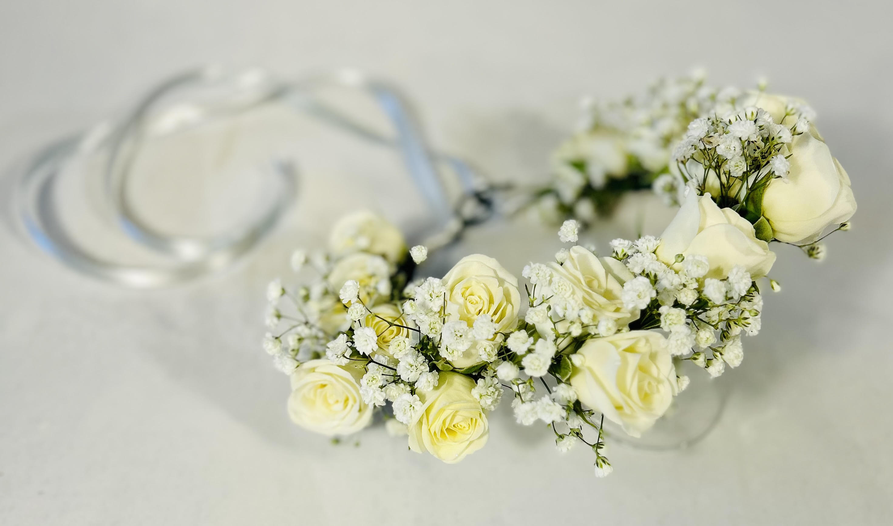 White rose floral crown with baby's breath on a clear band