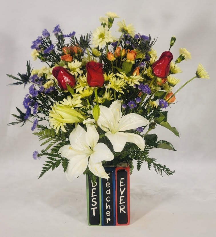 Mixed bouquet with white lilies, red roses, and purple flowers in a painted vase