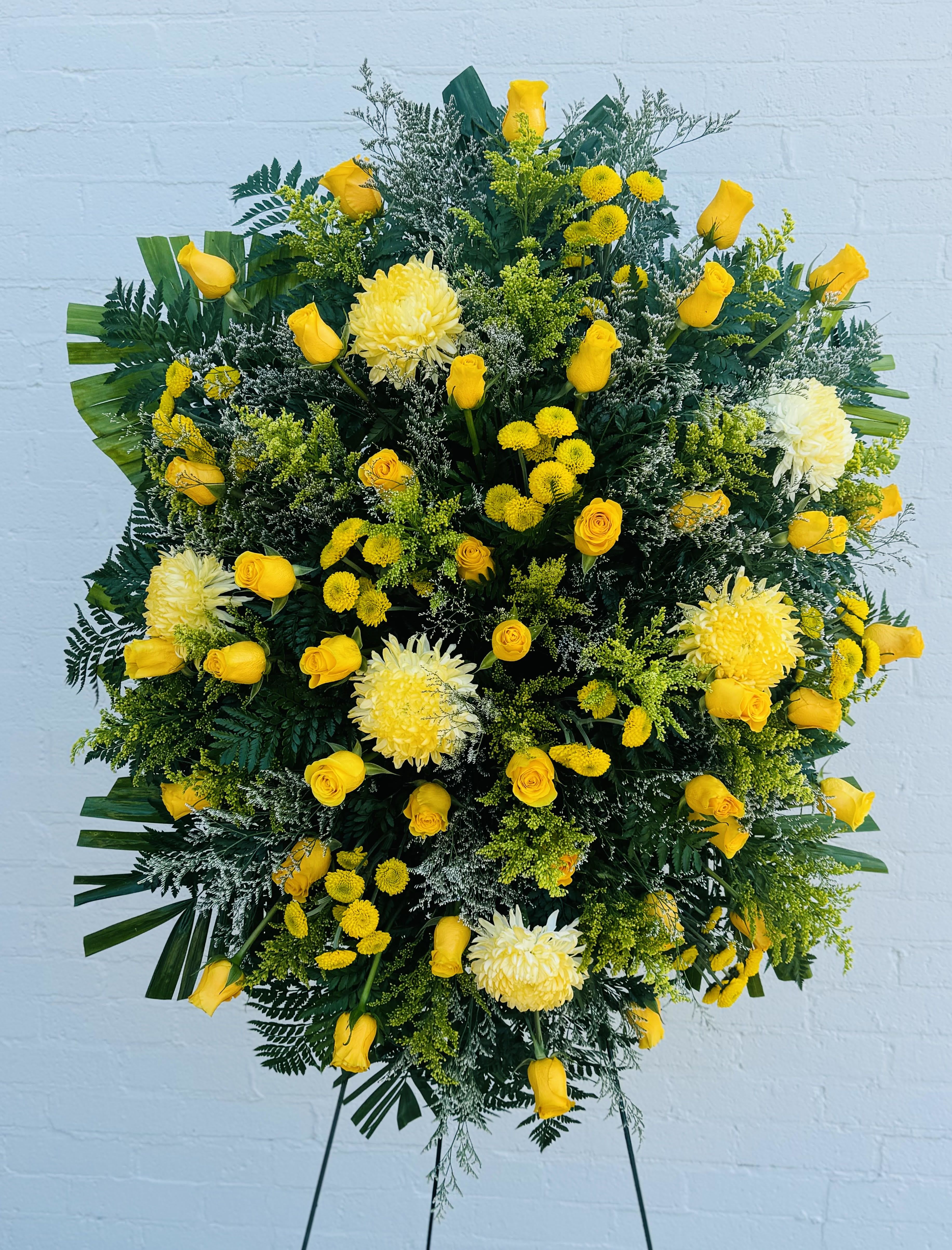 Large yellow floral standing spray with roses and chrysanthemums
