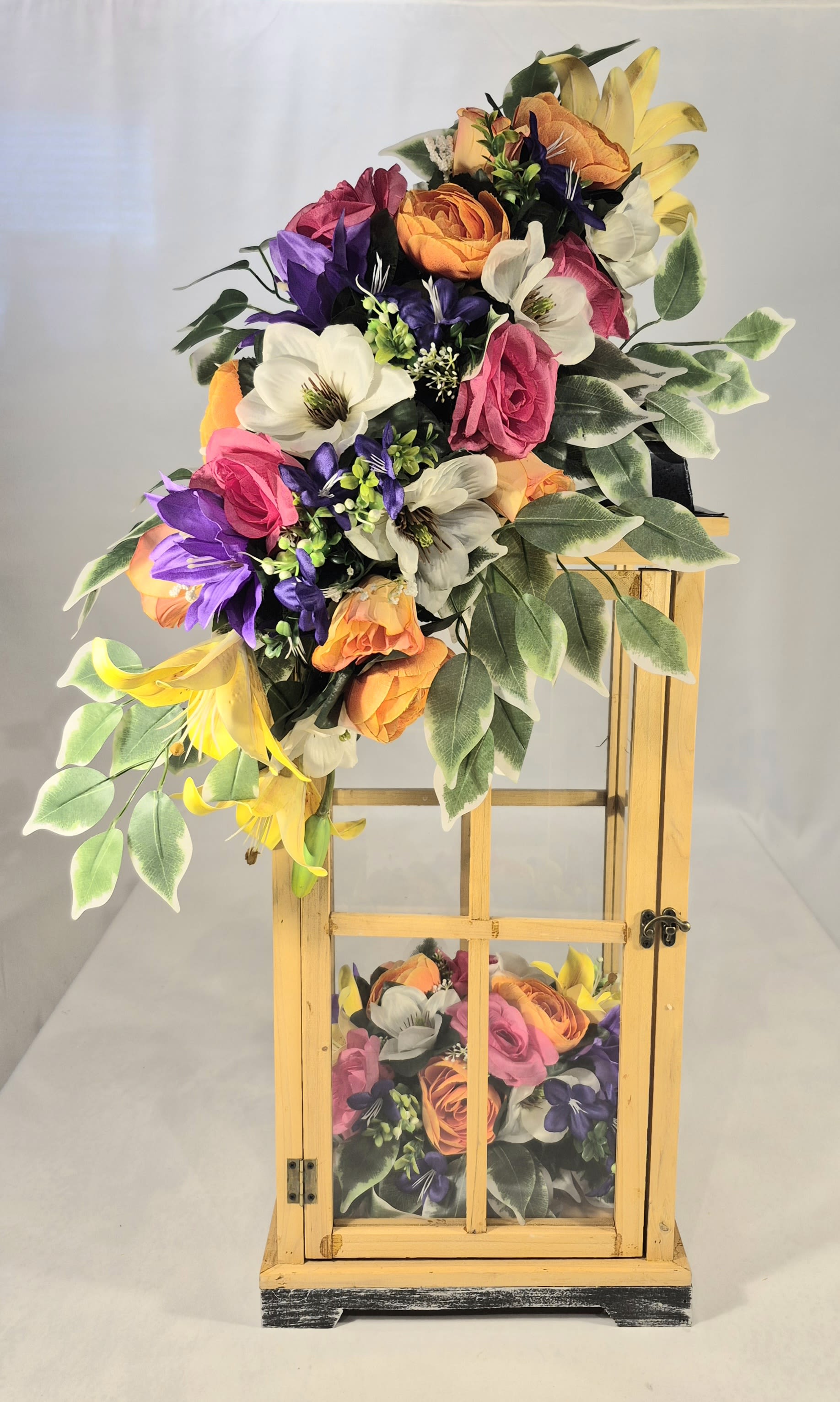 Colorful floral arrangement on a wooden lantern stand