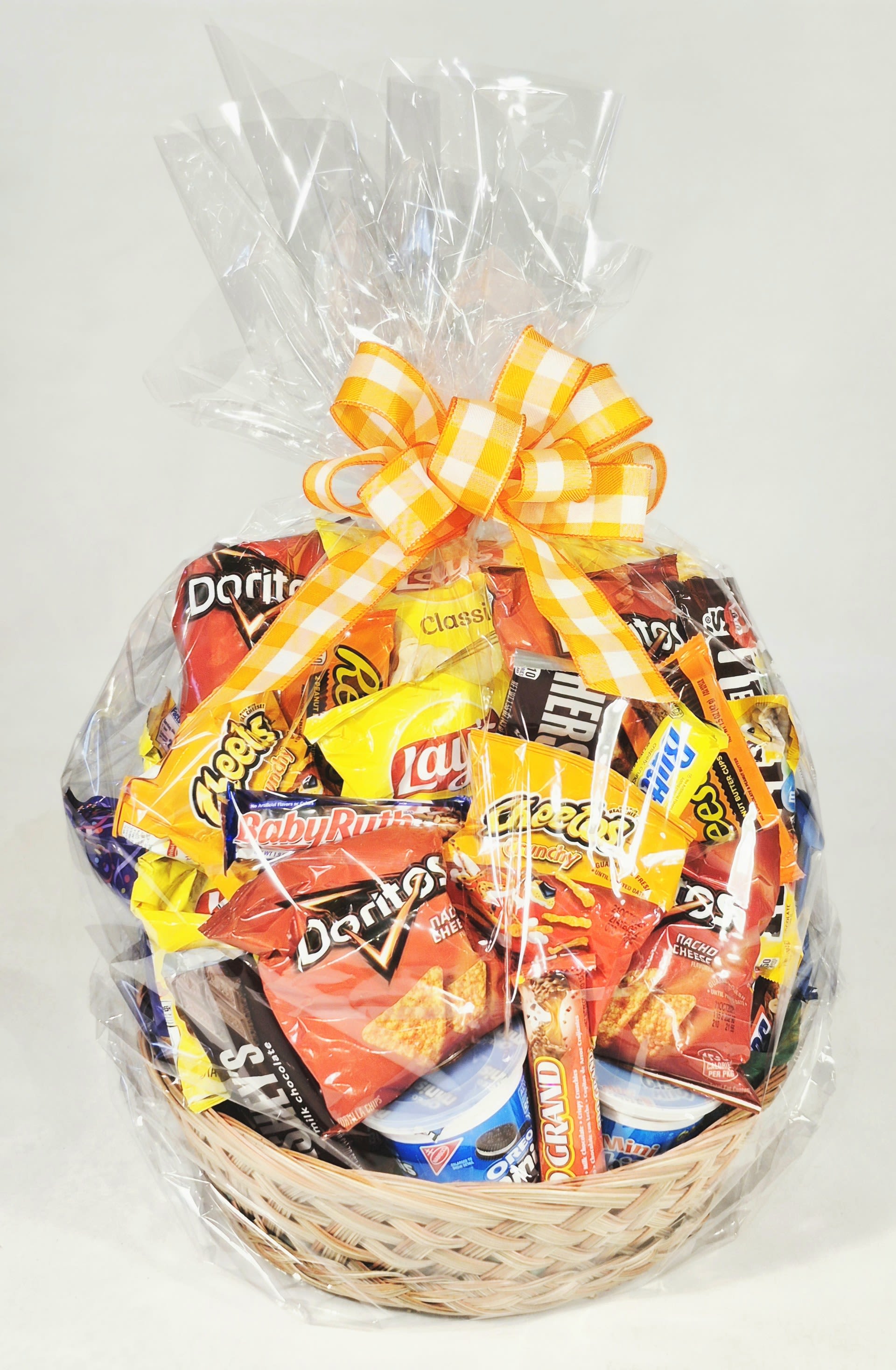 Basket of assorted snack bags wrapped in clear cellophane with a yellow ribbon