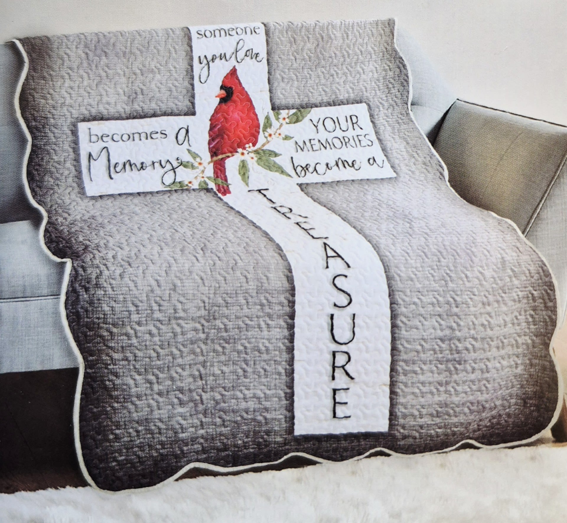 Quilted memorial pillow shaped like a cross with a red cardinal and text.