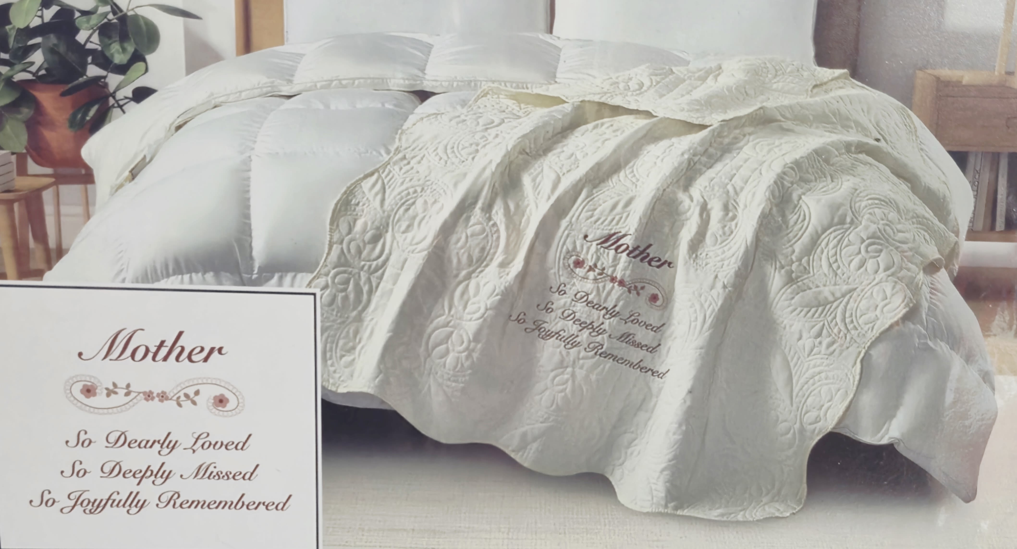 Mother Sympathy Quilted Throw - Soft, embroidered comfort designed to honor a mother's memory-this sympathy quilted throw is a gentle keepsake for remembrance and consolation. Intended for sympathy gifting or a memorial service, the cream-colored throw features the heartfelt tribute, "Mother, So Dearly Loved, So Deeply Missed, So Joyfully Remembered," rendered in elegant script with delicate floral accents that read clearly on the piece and on the accompanying printed sentiment card. The neutral palette of cream with muted pink and brown embroidery creates a calm, reflective mood suited to bedside display, a favorite chair, or as a comforting layer at services.  Crafted with intricate stitched patterns and an embroidered message, the 50 x 60-inch throw is soft to the touch and made to feel like a warm embrace. The product presentation pairs the blanket with a printed tribute card; an optional green metal easel stand is available for an additional fee to elevate the throw for ceremony display. Thoughtful and enduring, this quilted blanket offers a personal way to remember a mother-comforting for quiet moments at home or as a meaningful addition to a memorial arrangement.