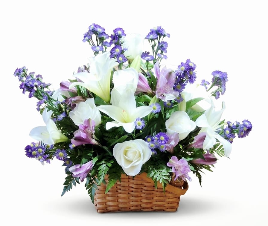 Gracious Lavender &amp; White Basket  - White lilies and white roses take center stage in this airy basket arrangement, a graceful everyday flower arrangement perfect for birthdays, thank you gifts, or a thoughtful "thinking of you" gesture. The calm white and purple palette - with lavender alstroemeria and purple aster-like blooms - creates a serene, springtime look that will make the person you're thinking of feel genuinely seen and comforted.  Arranged in a low woven basket, the composition is full yet light, with blooms extending outward in a balanced, rounded silhouette that reads fresh from every angle. Textures mix from the smooth petals of lilies and roses to the dainty asters and alstroemeria, complemented by green foliage for contrast. Sized to sit on a table or counter, this arrangement arrives ready to display and brings an elegant, uplifting presence to any room. 14" Tall