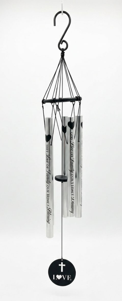 "The Love of Family is Life's Greatest Blessings" Wind Chime - A graceful, faith‑centered memorial wind chime that speaks to comfort and remembrance-perfect as a sympathy or funeral tribute. The metal wind chime features a black circular top frame and silver-toned tubes printed with hearts and family‑themed script that gently announce the sentiment "The Love of Family is Life's Greatest Blessings." The lower pendant bears a cross and the word LOVE, giving this piece a quiet, spiritual presence for indoor or outdoor hanging.  Hand‑tuned for clear resonance, this 37" piece (5" diameter x 37" height overall) includes a 2" hanging hook and a wind catcher pendant that carries the message and cross motif. The monochrome black-and-silver palette keeps the look solemn and versatile; it arrives ready to hang and will weather comfortably in a protected outdoor spot or sit peacefully in a memory corner indoors. A simple metal easel stand is available as an upgrade for display during services or at home.  Give this as a meaningful get well, Grandparent's Day, Mother's Day, Parent's Day, or Best Friends Day gift when you want to honor a deep connection or soothe a grieving heart. The design centers the recipient will feel remembered and cherished while the clear tuning and sturdy hardware ensure lasting beauty; select the deluxe option to include the stand for presentation.