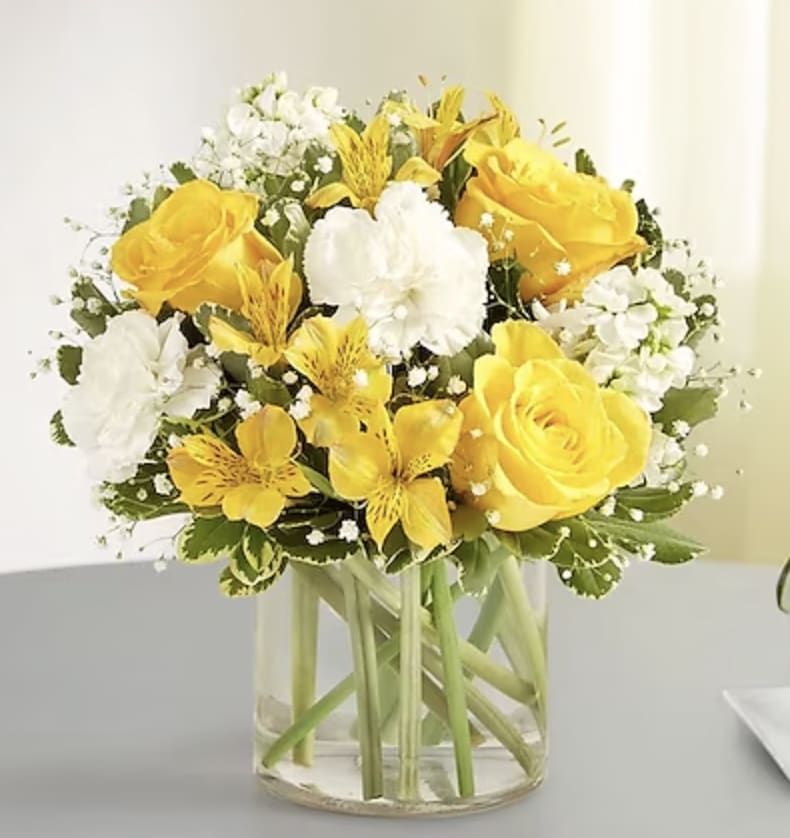 Yellow and white bouquet in a clear glass vase