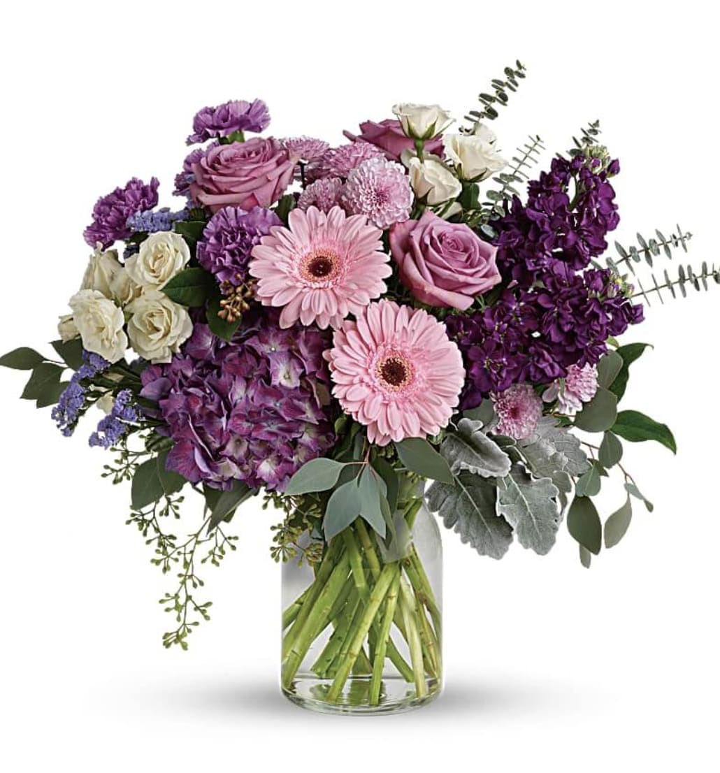 Grand Bouquet - Bring beauty to any occasion with the deep purples and playful pinks of this breathtaking bouquet. This magnificent bouquet features purple hydrangea, lavender roses, crème spray roses, pink gerberas, lavender carnations, purple stock, lavender cushion spray chrysanthemums, lavender statice, dusty miller, spiral eucalyptus, seeded eucalyptus, silver dollar eucalyptus, and lemon leaf. 