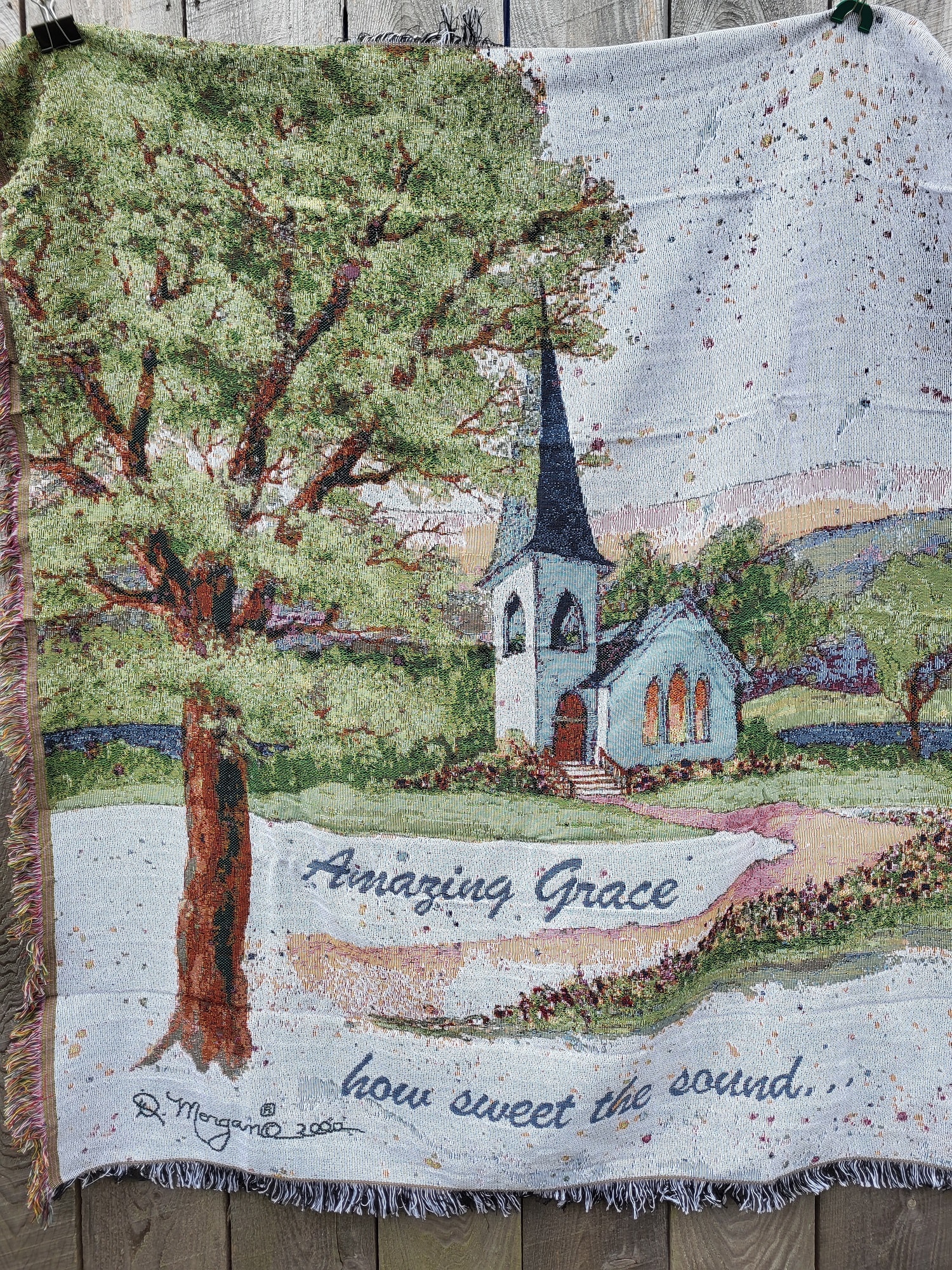 Woven blanket with a church scene and the words "Amazing Grace"