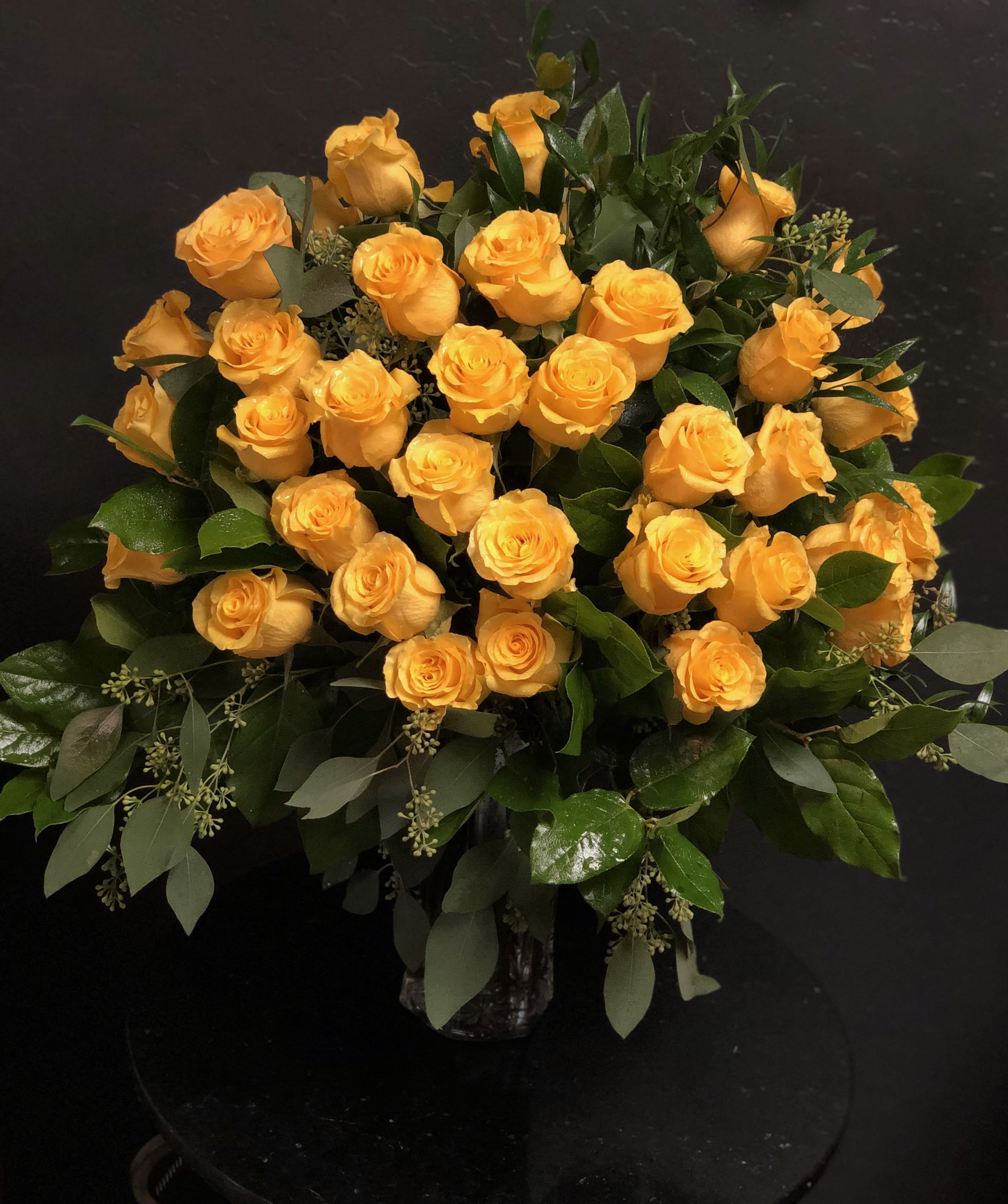 Bouquet of yellow roses in a glass vase