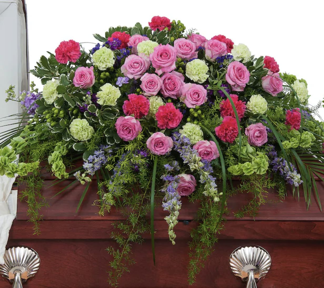 Pink and green floral casket spray with roses and carnations