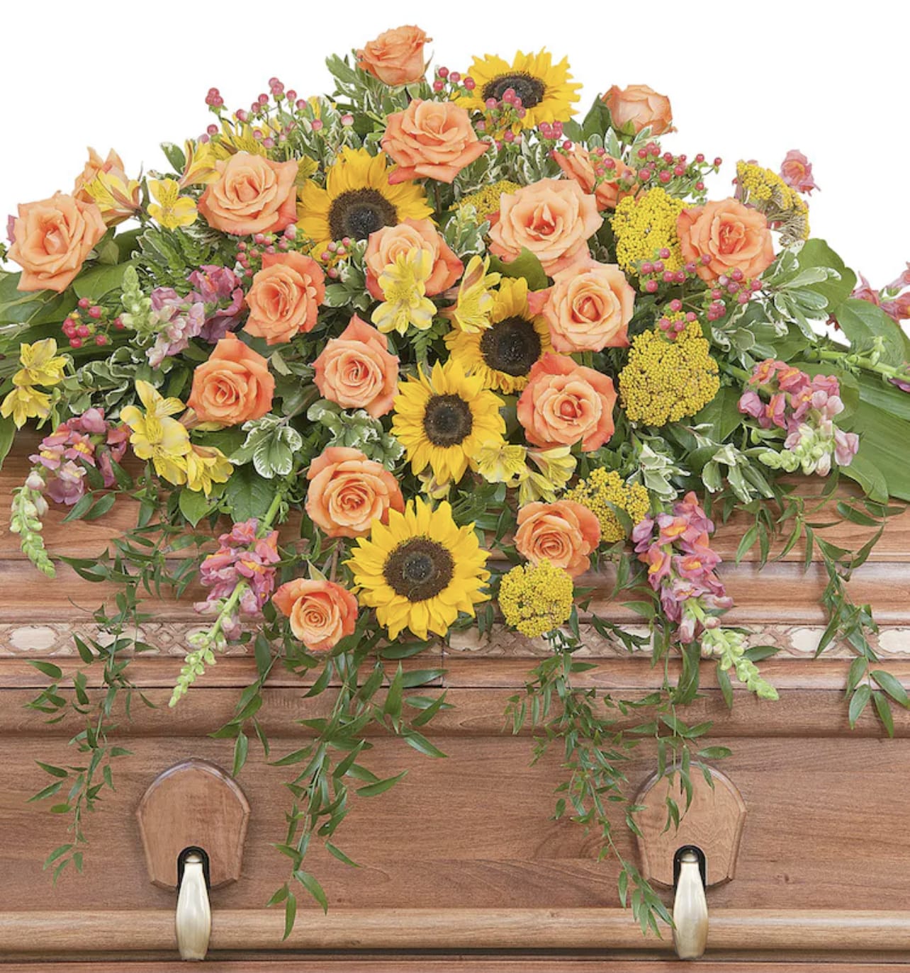 Casket spray with peach roses and yellow sunflowers