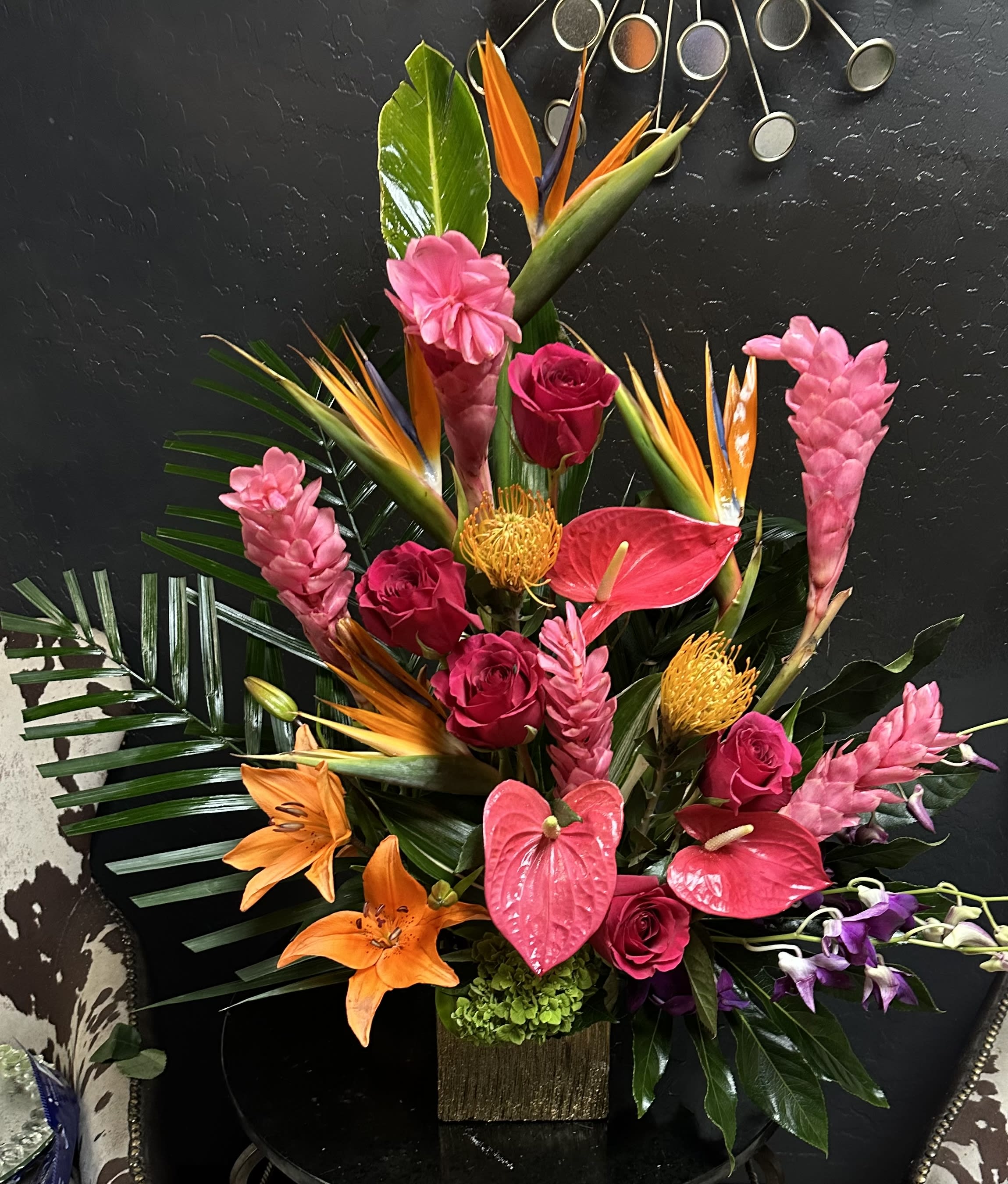 Tropical arrangement with pink roses, anthuriums, lilies, and bird-of-paradise