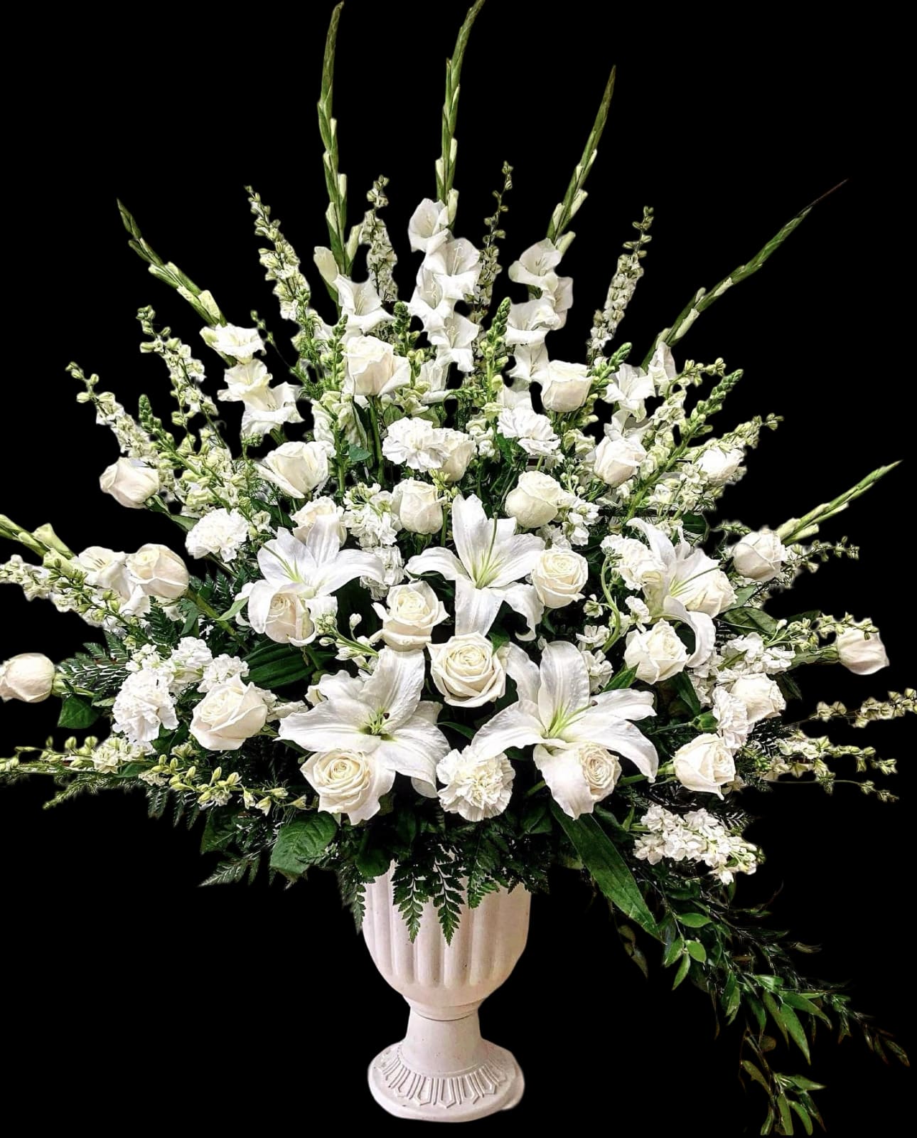 White roses and lilies in a pedestal vase