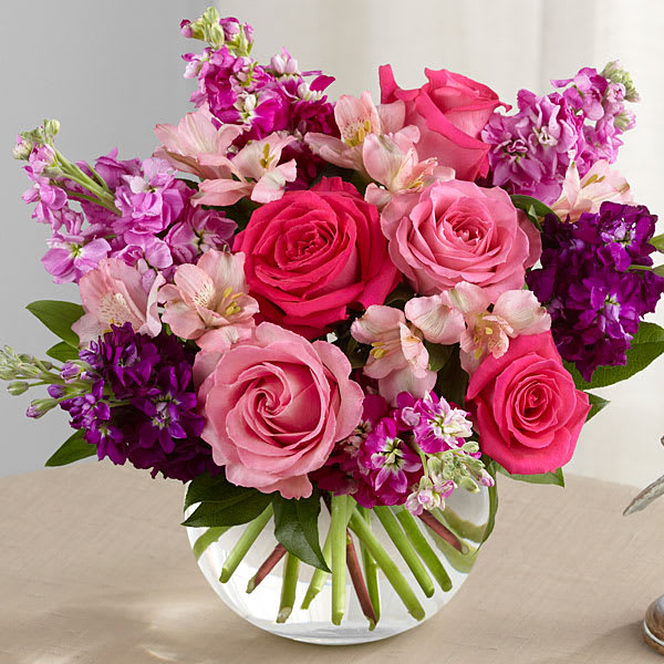 Tranquil Bouquet - The FTD® Tranquil™ Bouquet blooms with a sweet sophistication and style to bring a calming grace to any event or occasion. Hot pink and pink roses are brought together with purple, lavender and fuchsia stock stems accented with pink Peruvian lilies and lush greens to create a simply stunning flower arrangement. Presented in a clear glass bubble bowl vase, this exquisite fresh flower bouquet will make an excellent birthday, anniversary or sympathy gift. BETTER bouquet stands approximately 13"H x 14"W.
