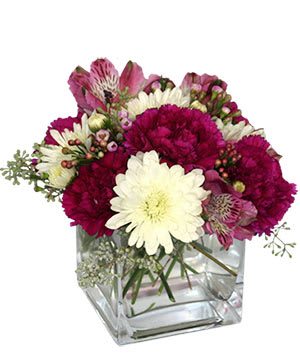 Pink and white mixed bouquet in a clear square vase