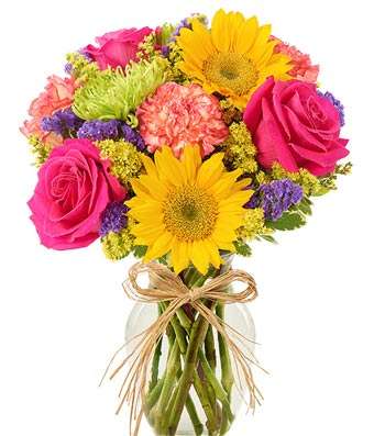 Bouquet of pink roses and yellow daisies in a glass vase with a ribbon