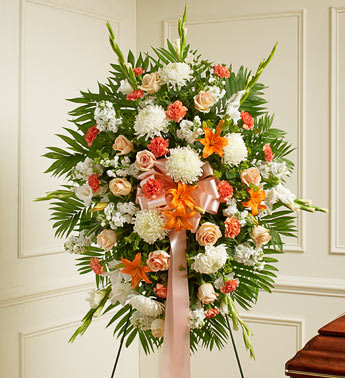 Deepest Sympathy Standing Spray-Peach/Orange/White - Product ID: 91293   This Sympathy Standing Spray, in shades of peach, orange and white, is a beautiful symbol of your sympathy and support. Peach roses, orange Asiatic lilies, white carnations and more An appropriate gift for family, friends and business associates to send directly to the funeral home Our florists use only the freshest flowers available so colors and varieties may vary Large measures approximately 52"H x 42"L without easel Medium measures approximately 46"H x 38"L without easel Small measures approximately 42"H x 30"L without easel