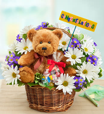 Lotsa Love Congratulations - Product ID: 95453  EXCLUSIVE Congratulate the graduate in a big way! This Lotsa LoveÂ® gift is fun and heartfelt, and has all the makings of a celebration. Our florists will deliver your best wishes with a hand-designed basket arrangement of bright blooms, an exclusive plush bear, a bag of tasty candies and, of course, a âCongrats!â balloon. Bright and beautiful arrangement of white poms, lavender monte casino, salal and variegated pittosporum Expertly designed by our florists in a handled willow basket and accented with a felt "Congratulations!" pick; basket measures 8"H Arrives with an 18"D Mylar "Congrats!" balloon; design on balloon will vary due to local availability Our cuddly Lotsa LoveÂ® plush brown bear with brown satin bow; plush measures 10"H and is safe for ages 3 and up Also includes a bag of delicious assorted candy; assortment may vary Arrangement measures approximately 12"H x 12"L Our florists select the freshest flowers available so colors and varieties may vary