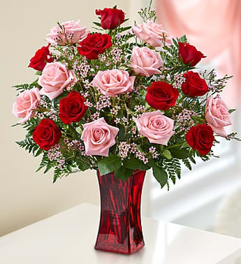 Shades of Pink and Red - Premium Long Stem Roses - Product ID: 91457  EXCLUSIVE She'll be blushing for sure when our beautiful bouquet of pink and red long-stem roses arrives at the door! Hand-gathered by our expert florists in a rich red vase, we canât think of a more colorful way to express yourself to someone very special. Gorgeous bouquet of premium long-stem pink and red roses, accented by fresh waxflower and salal Artistically arranged by our expert florists in a stylish red glass gathering vase; measures 9"H Large arrangement has 18 stems; measures approximately 20"H x 14"L Small arrangement has 12 stems; measures approximately 18"H x 12"L Our florists select the freshest flowers available so colors and varieties may vary