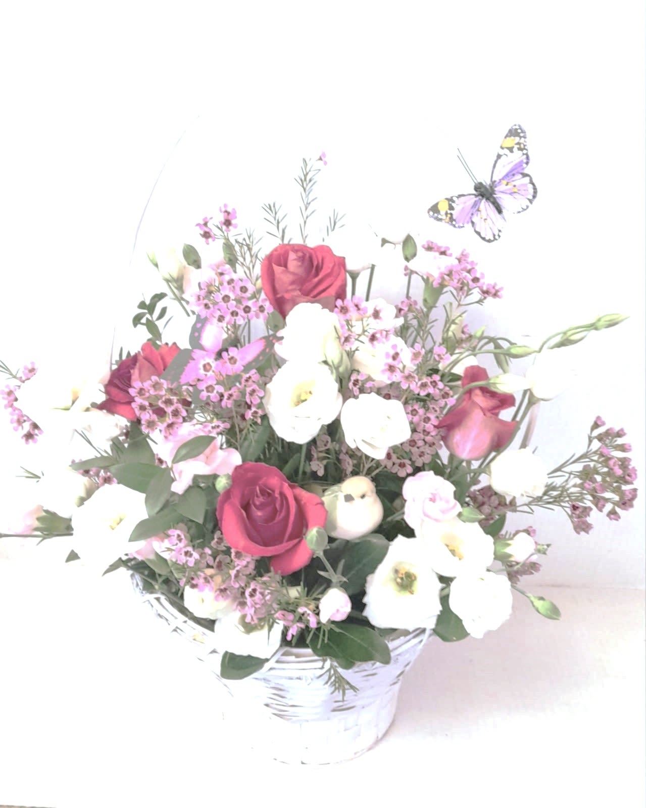 Butterfly Garden Premium - A large and beautiful mixture of roses, assorted flowers and fillers, butterflies and a bird in a large basket.