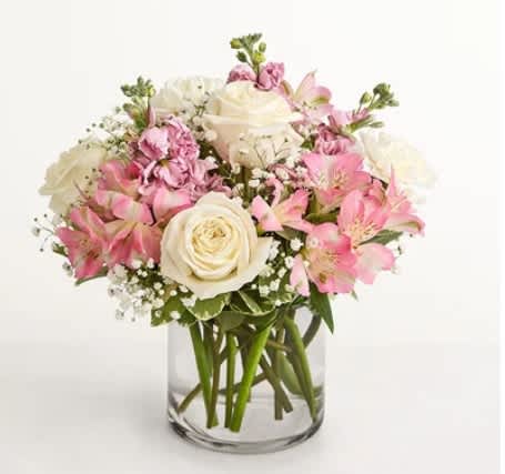 Pink and white bouquet of roses and alstroemeria in a clear glass vase