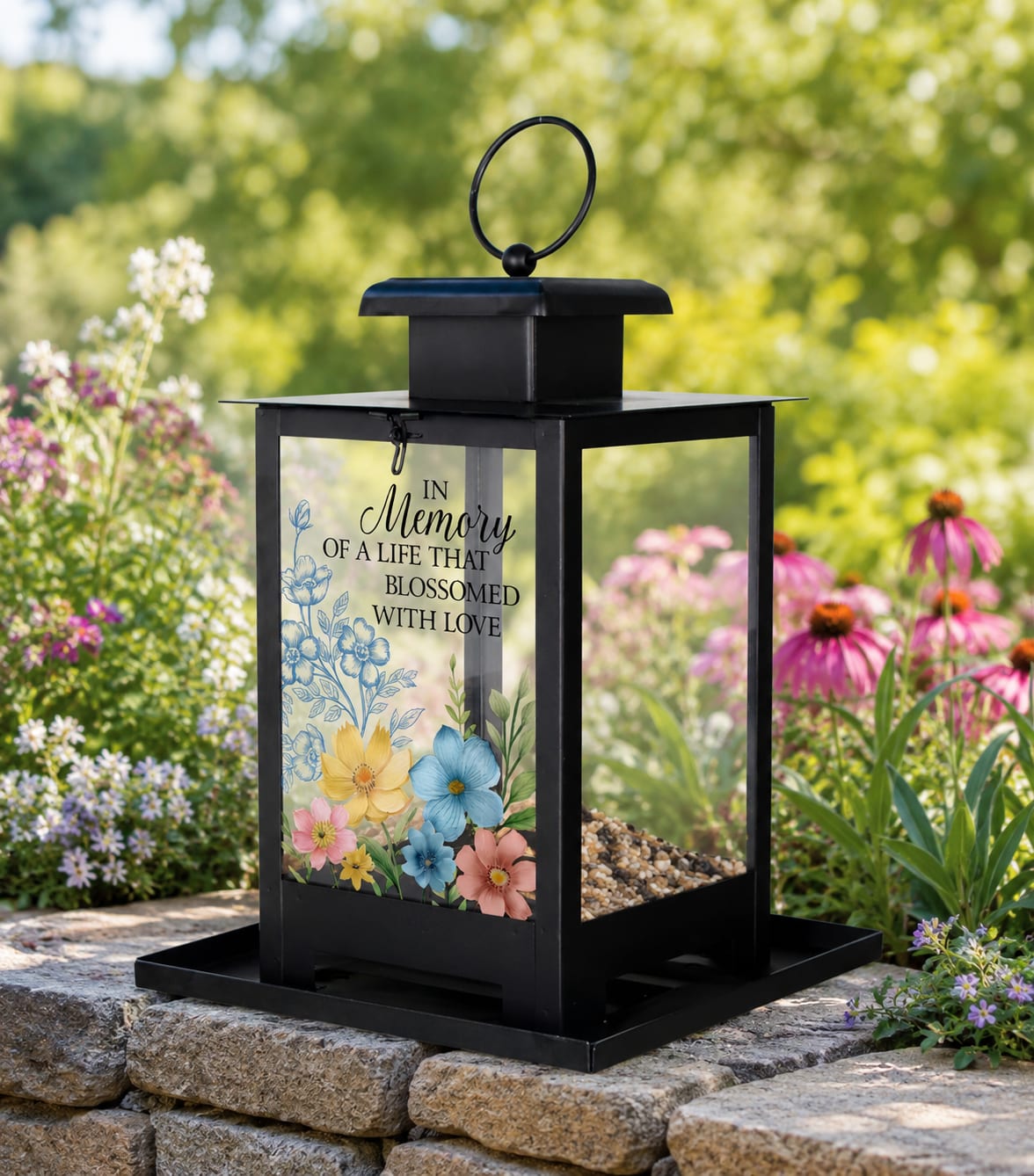 "In Memory" Bird Feeder 11960 - Add beauty, comfort, and quiet reflection to any garden or outdoor space with this decorative memorial bird feeder. Designed with soft floral artwork, meaningful sentiment details, and durable metal construction, this keepsake piece creates a peaceful focal point for patios, porches, walkways, remembrance gardens, and celebration-of-life settings.  The decorative artwork is printed directly onto the panel for a lasting finish with elegant color and detail. Whether placed among flower beds, on a garden wall, near a favorite bench, or in a personal memorial space, this bird feeder offers a thoughtful alternative to traditional gifts while blending naturally into outdoor décor.  Available in presentation options accented with decorative ribbon or topped with a coordinating fresh flower spray for a fuller garden-inspired display. Suitable for sympathy gifts, remembrance gestures, encouragement gifts, anniversaries, thinking-of-you occasions, or everyday garden decorating.  A meaningful keepsake designed to bring lasting beauty, gentle comfort, and a sense of peace long after fresh flowers fade.