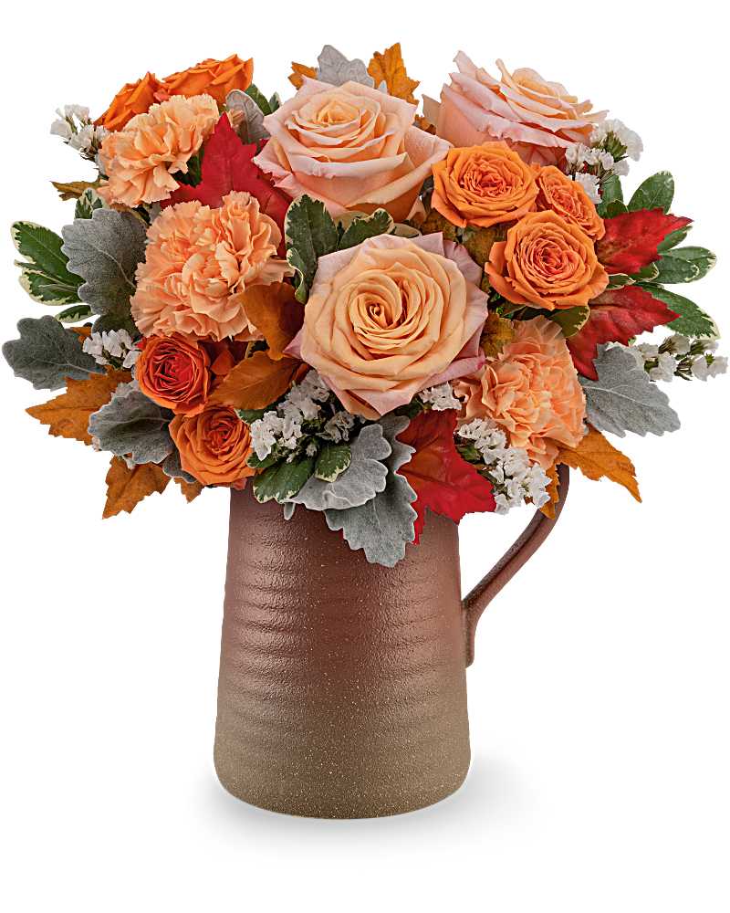 Bouquet of peach and orange roses in a brown pitcher vase