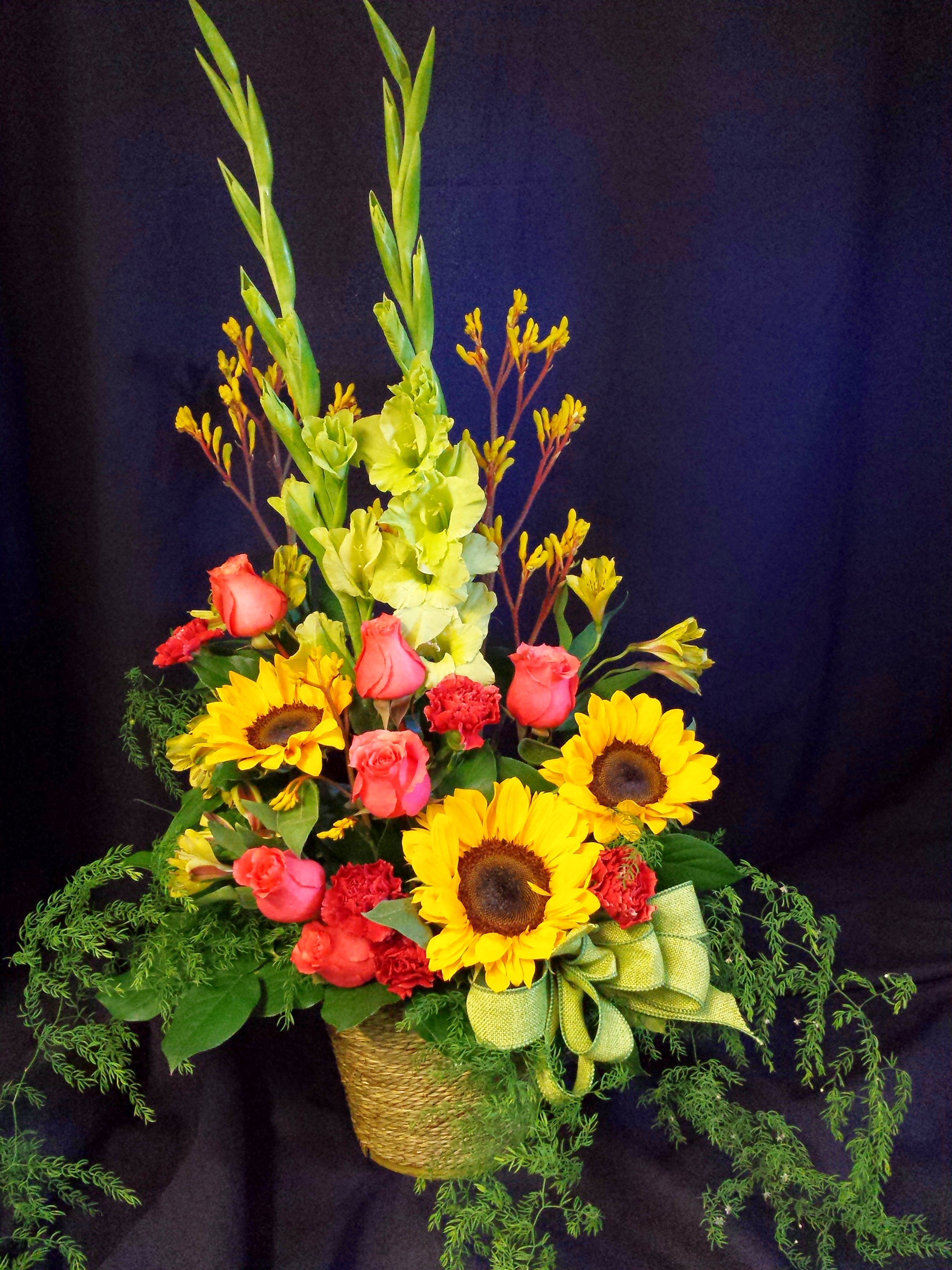 Basket Mixed Flowers and Roses for Memorial - flowers will vary - Cost effective basket arrangement of Colorful flowers for a Celebration of Life or Memorial service. Includes a seasonal selection of flowers (items will vary and depend on what colors and flowers we have in stock).  Medium size. Can be taken home by the family after the service.   