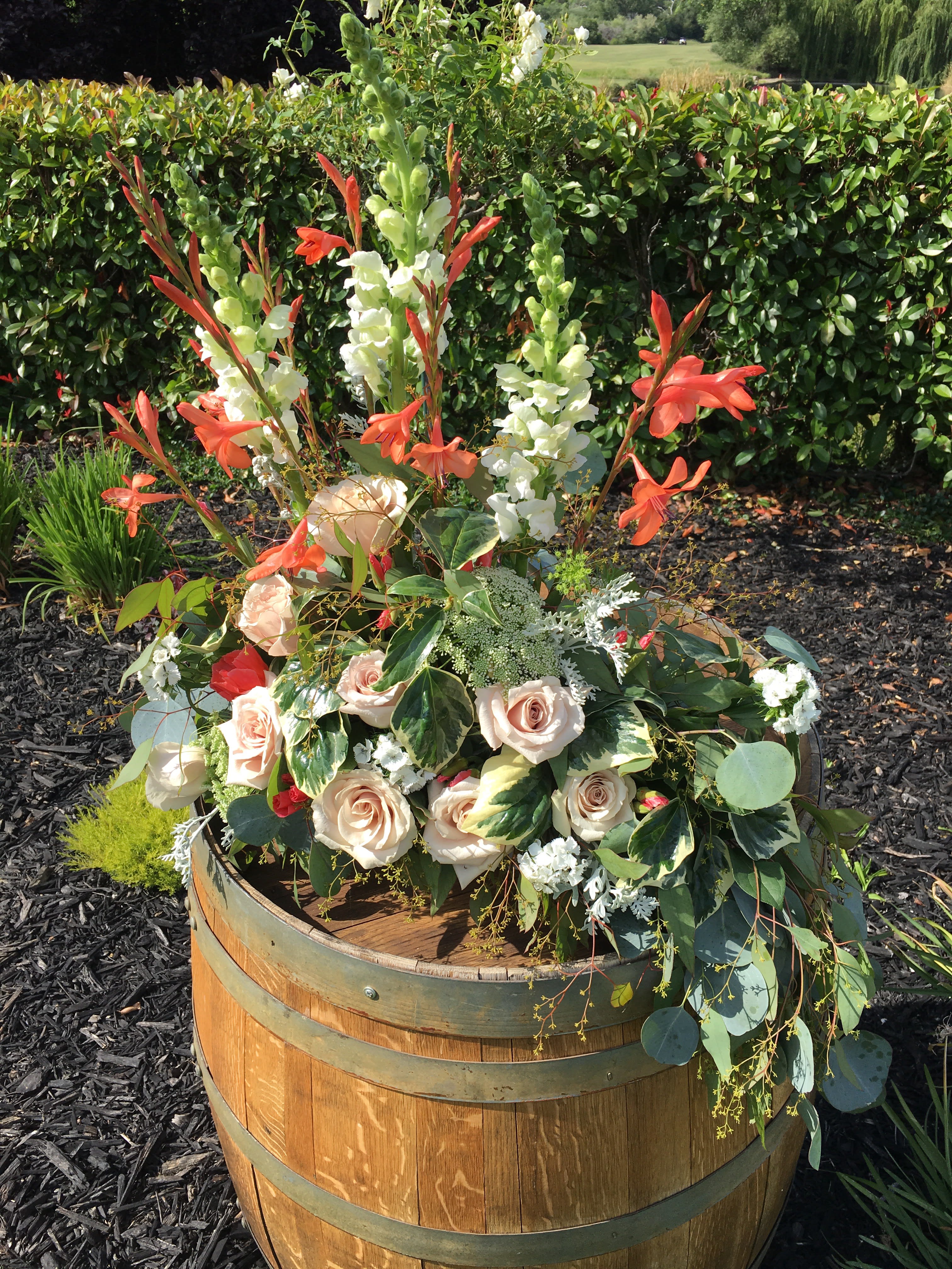 L shape Rose arrangement for Altar - Designed with all flowers facing one direction (back has no flowers)  to decorate the front of the church altar area.  This is an L shape of a natural and graceful flowing design. If you would rather it be symmetrical, please note your request in the comment section. Arrangement is approximately  18 inches tall and 30 inches wide. Flowers will vary. Order at least a week ahead if you have color preferences.
