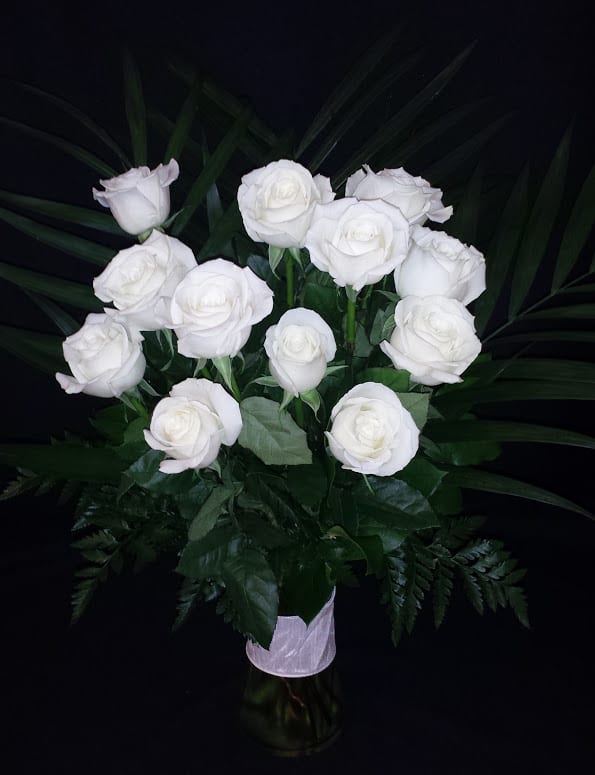 Dozen Understated White Roses  - When less is more, order these elegant premium medium length roses and nothing else. White will be substituted with a color if unavailable, especially due to shorter than 1 week's notice on the order / 3 weeks prior to Valentine's day. We will email you if a substitution is needed.  Please reply quickly. In some cases if we do  not hear back, we will cancel the order.  Our roses are arranged in a nice vase with a ribbon clutch or bow and gorgeous fresh premium foliage.  Foliage and vase type may vary.  The white roses we carry are Colombian roses and Ecuadorian roses, which are much bigger than red California roses.