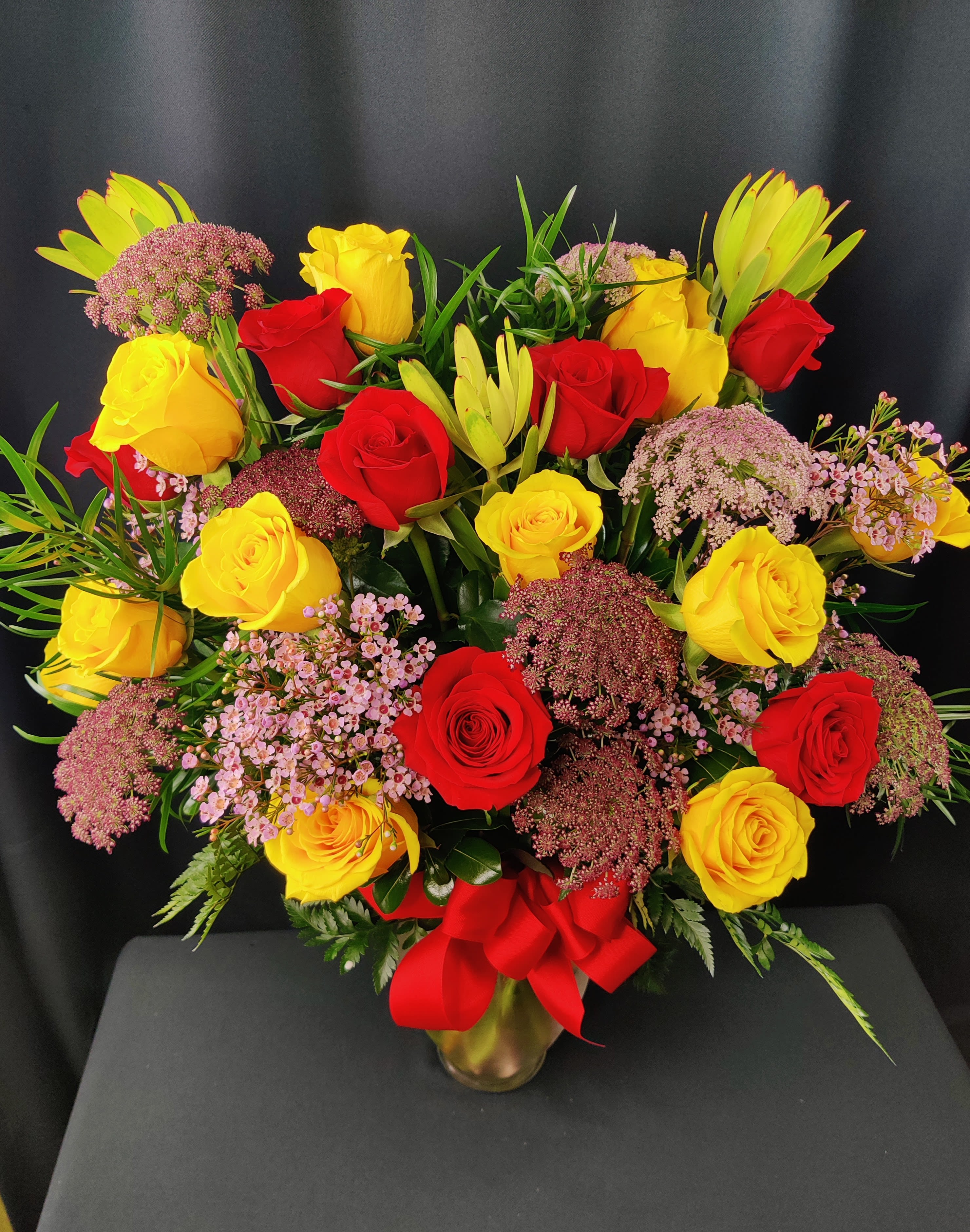 Chinese New Year Roses - Bold Gold and Red Roses for Chinese NEW YEAR! Let's celebrate with a giant long stem rose bouquet. Accent flowers may vary. Approximately 20 Roses. 