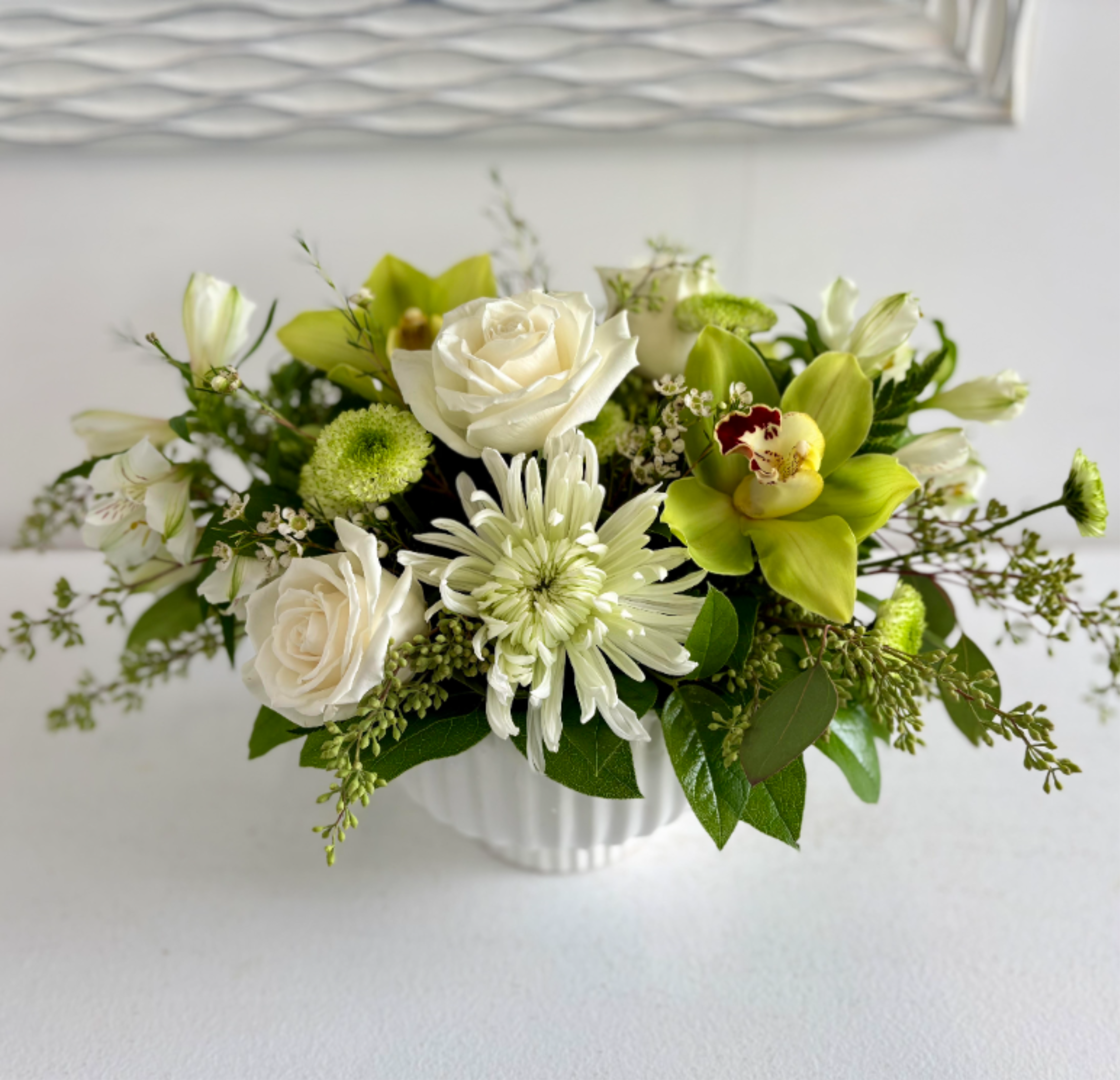Pure Grace  - Timeless and effortlessly elegant, Pure Grace is a classic arrangement of fresh white blooms designed to bring a sense of beauty and serenity to any space. Soft, natural tones and lush seasonal flowers come together in a refined, graceful design—perfect for celebrating, gifting, or simply brightening someone’s day.
