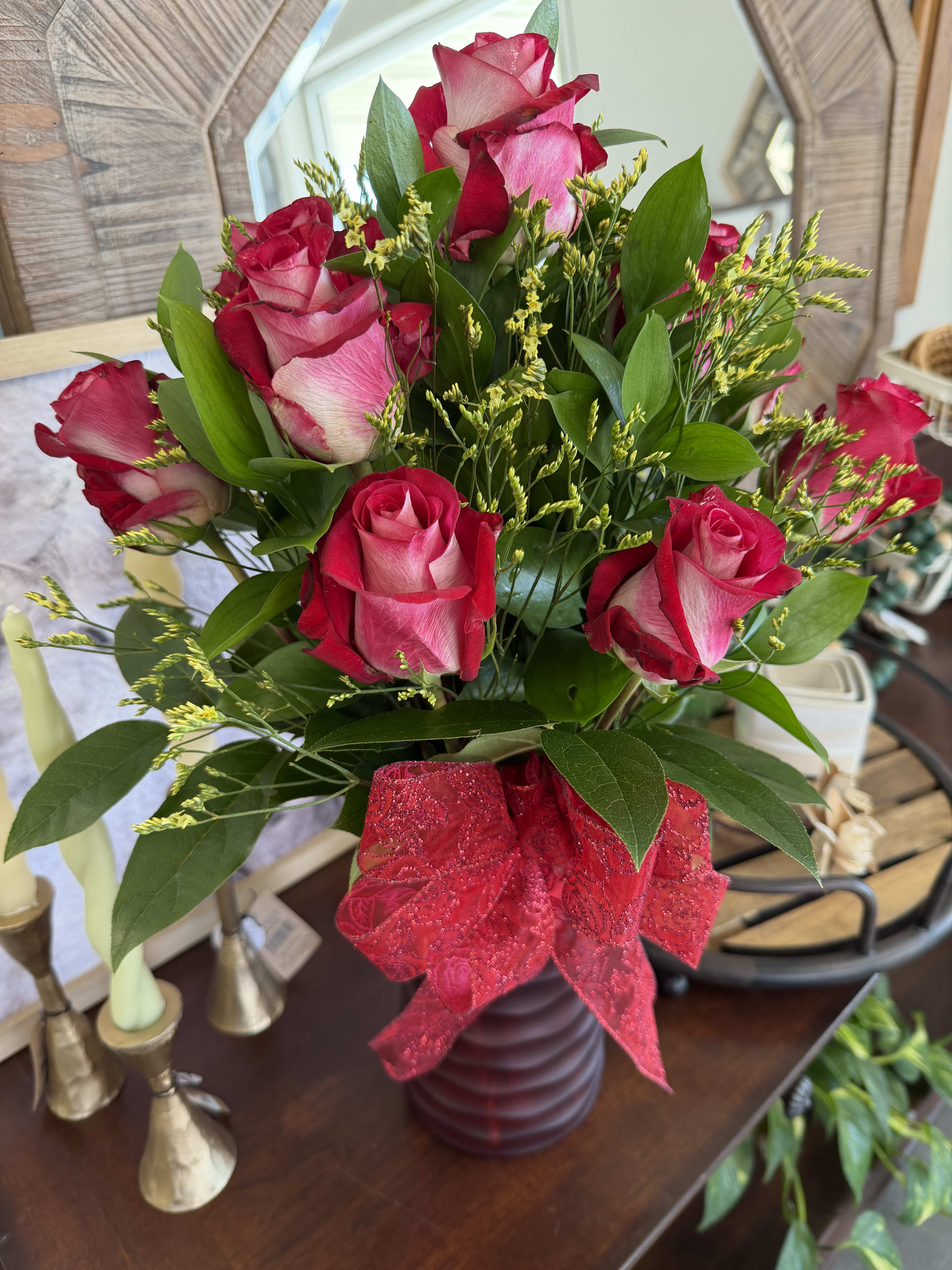Bouquet of pink roses in a burgundy vase