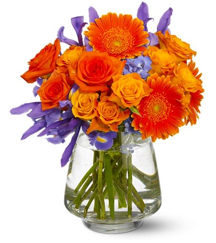 Orange and purple mixed bouquet in a clear glass vase