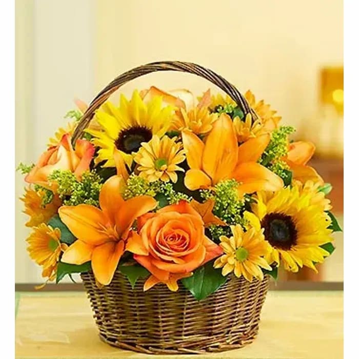 Fields of Europe Fall Basket - Reminiscent of the gorgeous blooms you'd find in a European flower market, this fresh take on our bestselling Fields of Europe™ arrangement gathers Autumn roses, sunflowers, lilies, oak leaves and more in a rustic handled basket.