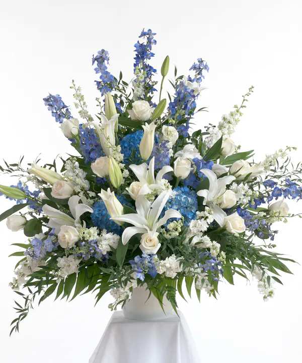 Blissful Moments  - Healing Love Bouquet is a wonderful way to offer your heartfelt condolences for your special recipient's loss. Weaving together a bold assortment of blooms, this fresh flower arrangement consists roses, lilies, hydrangea delphinium and more designed in a traditional style.  celebrating the life of a loved one at a visitation, funeral, church service, cremation, or cemetery service – or as a delivery to the family's home