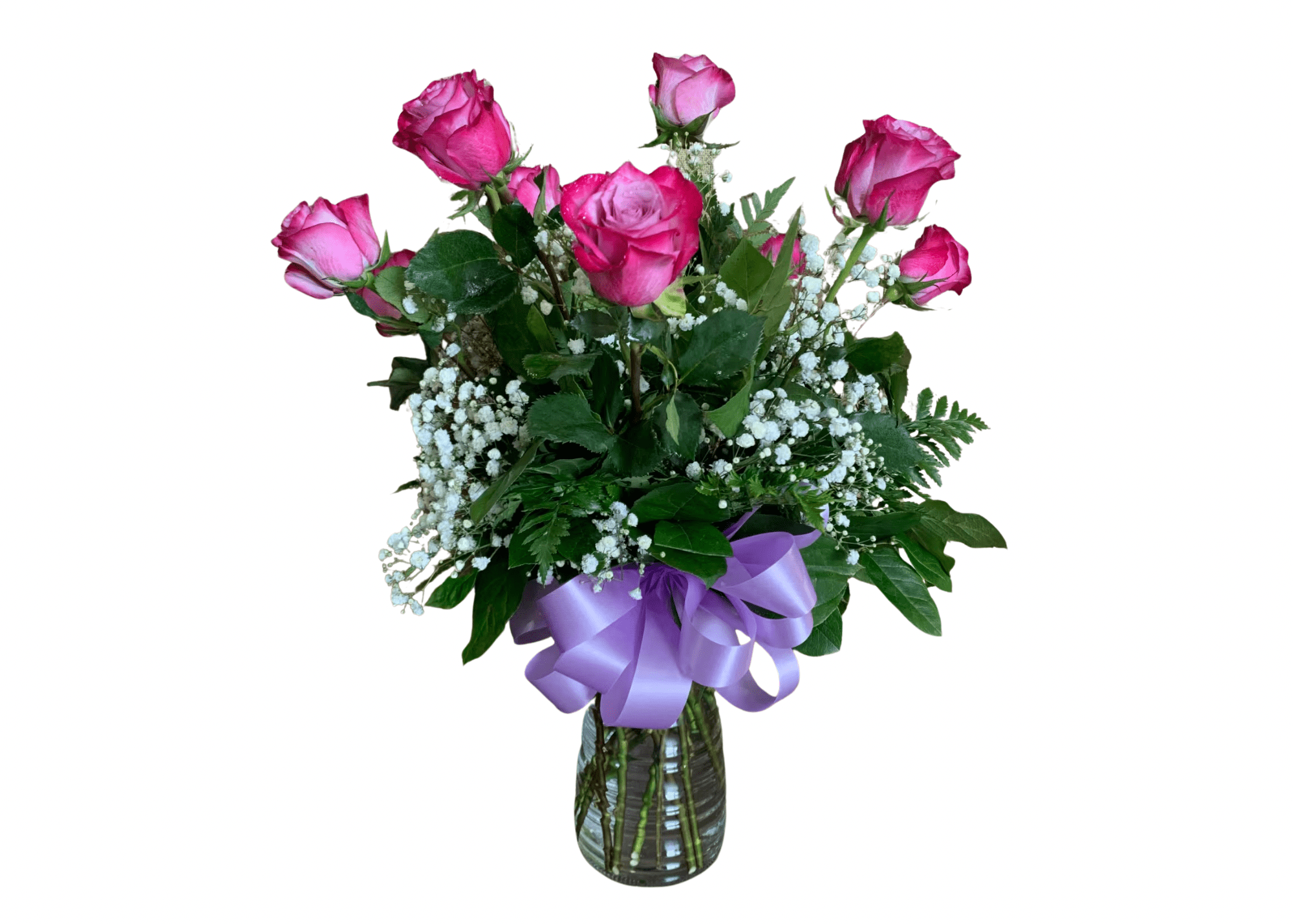 Medium vase arrangement of pink roses with white filler flowers and a lavender ribbon bow