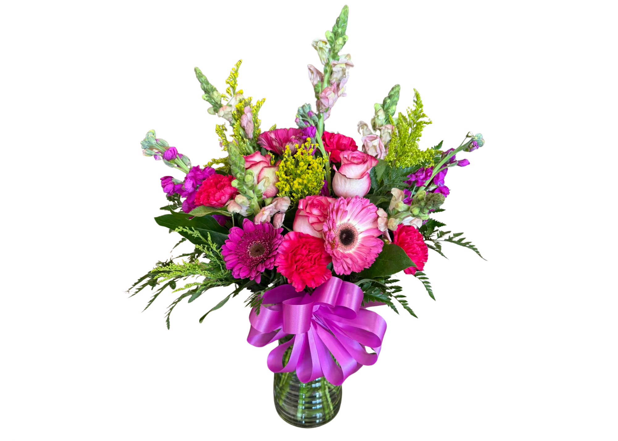 Bright pink and purple mixed flower arrangement in a green glass vase with a large purple bow