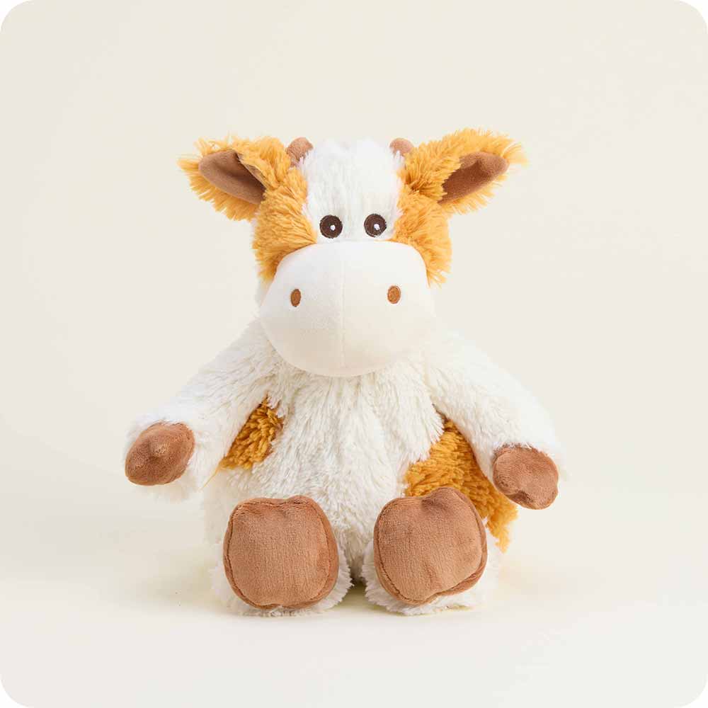Plush cow toy with white and orange fur