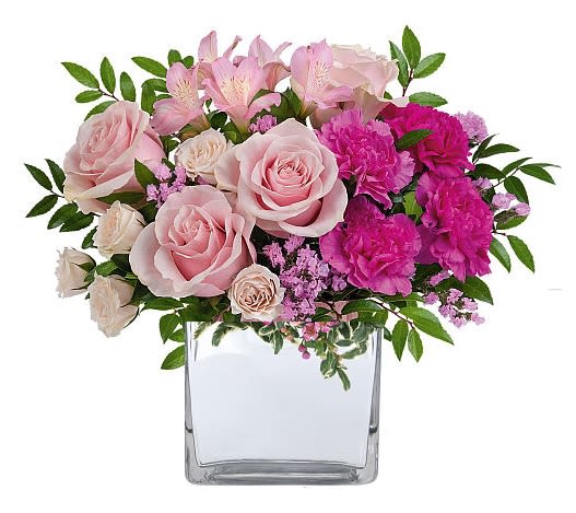 Pink roses and carnations in a clear glass vase