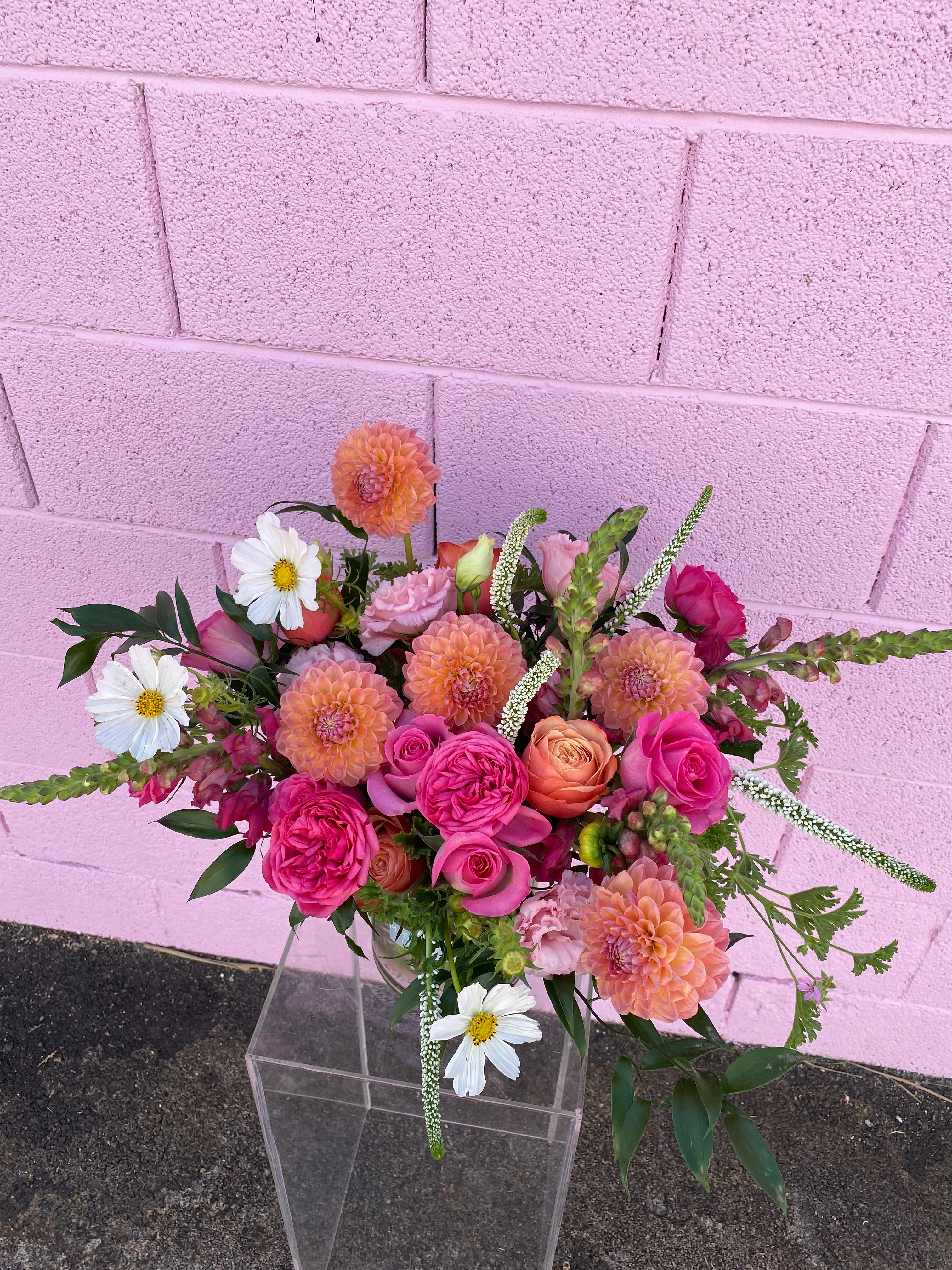 Pink and peach mixed bouquet in a clear vase
