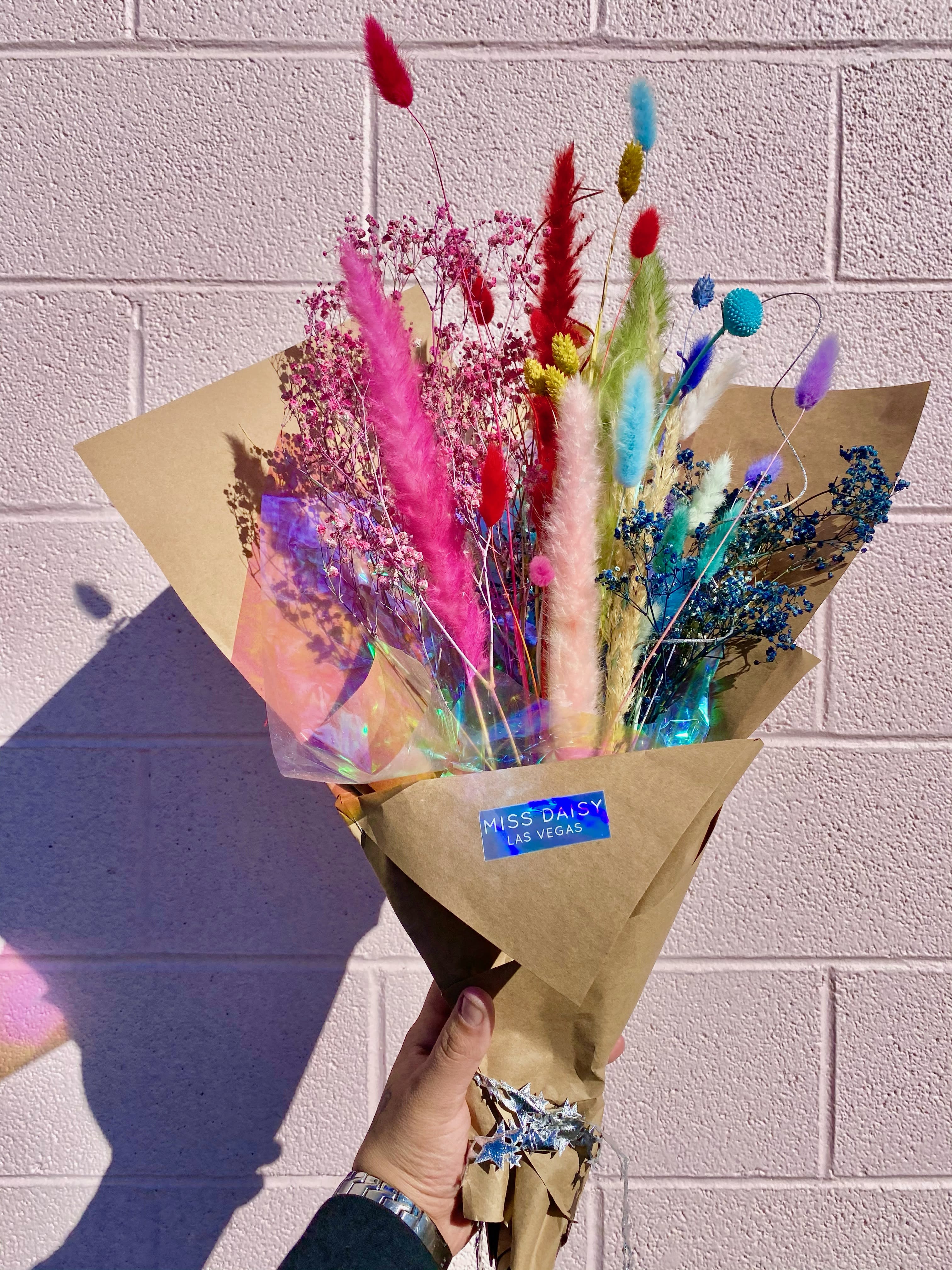 Rainbow Cloud - Dried Floral Arrangement - This long lasting all dried floral arrangement is made up of beautiful dried florals that are tinted by our creative designers and hand wrapped! Please note there are NO fresh flowers in this hand tie, and it does NOT come with a vase ( If you would like a vase, please give us a call and we can make that happen!) These beauties can live out of water and will last you a very long time!