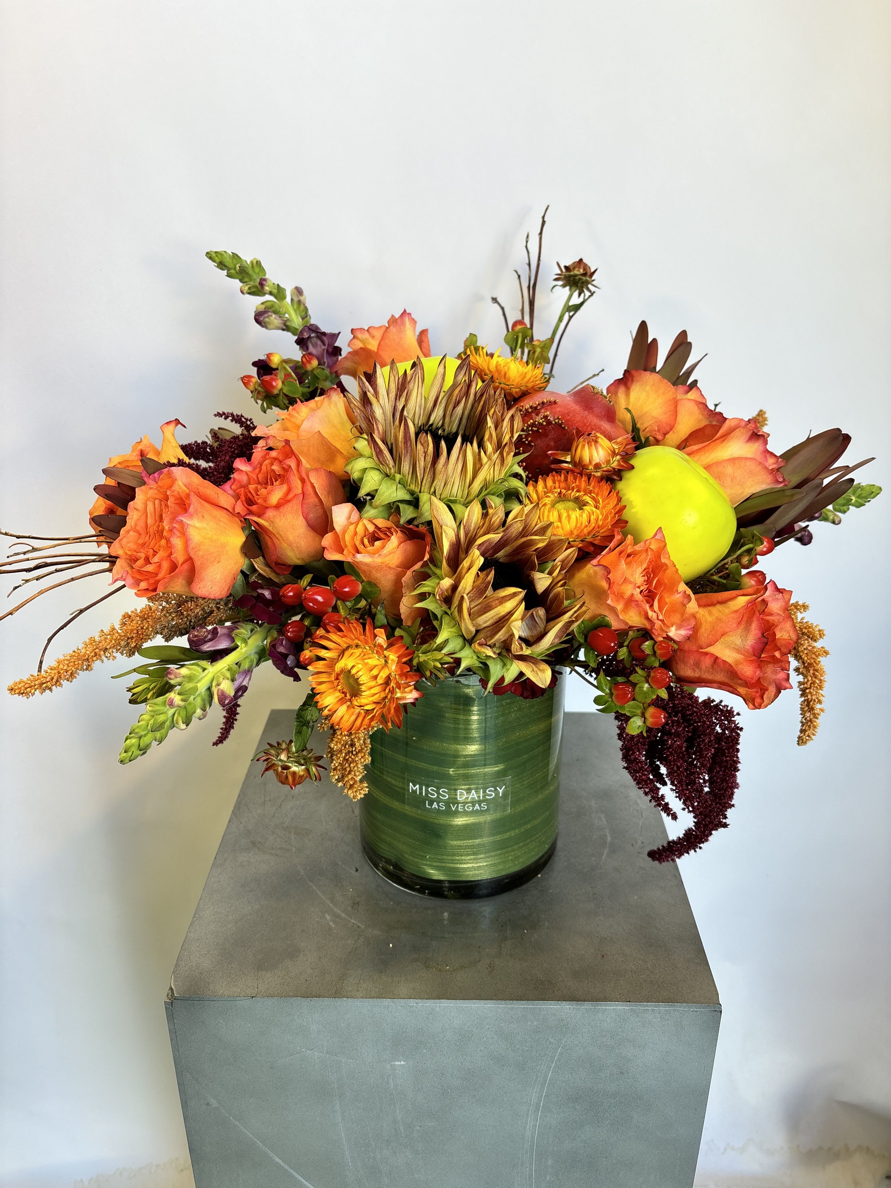 Apples and Honey - A festive fall forward new year arrangement filled with seasonal blooms and pops of apples and pomegranates!