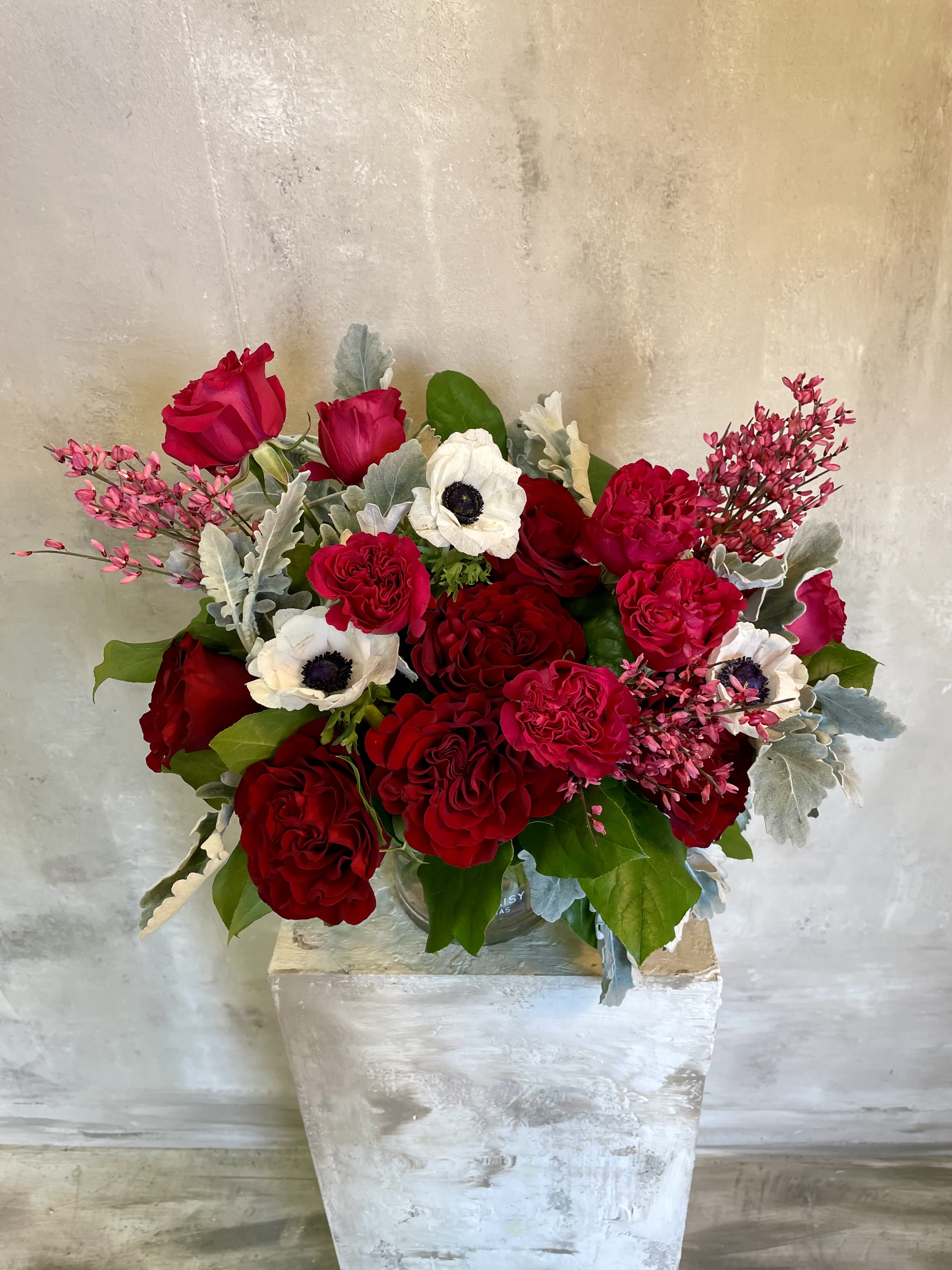 Red and white rose bouquet in a clear vase