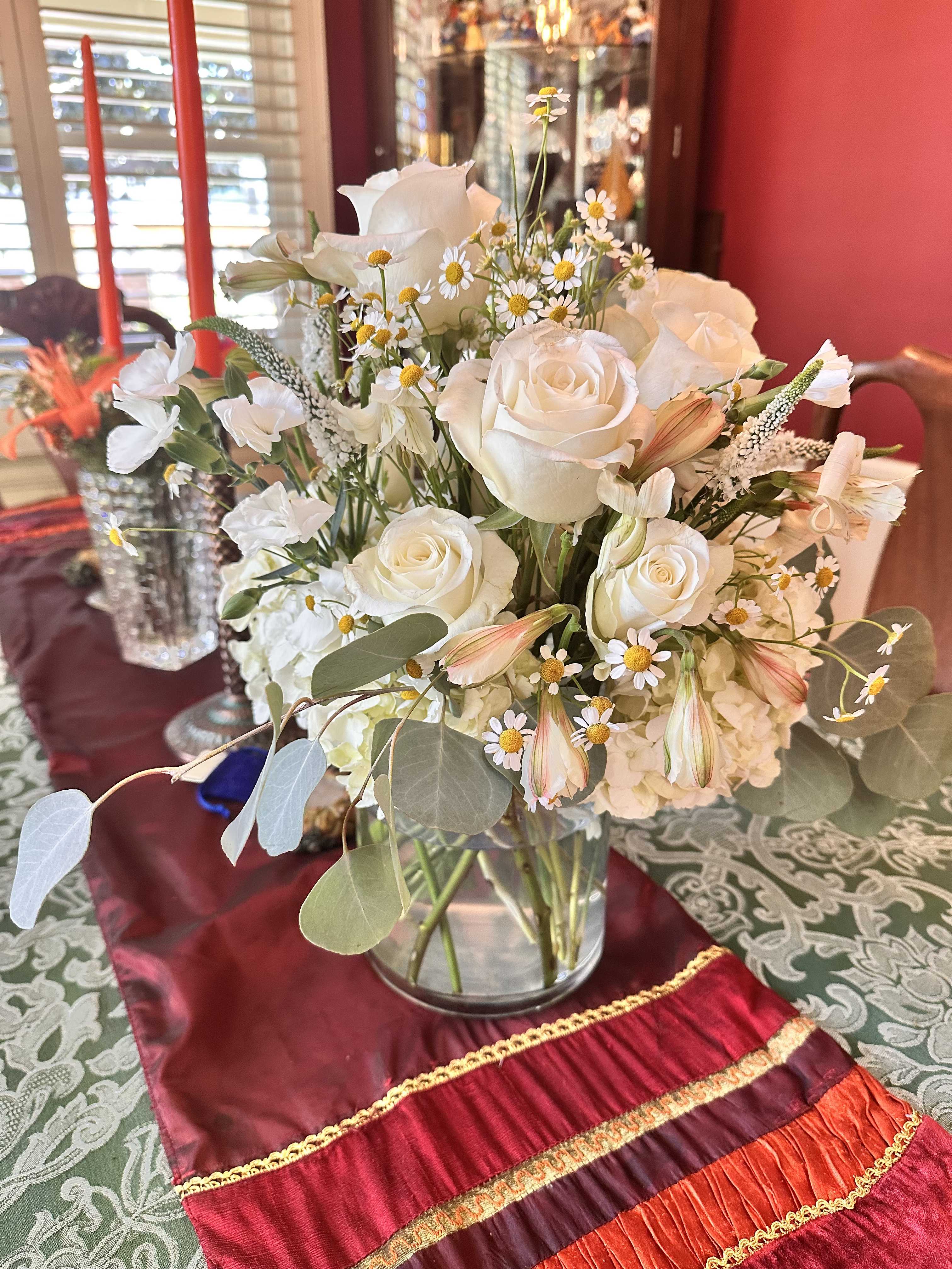 White rose bouquet in a clear glass vase