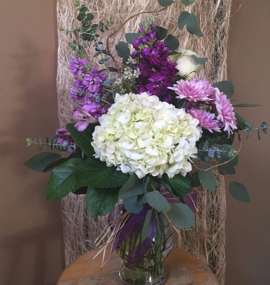 Purple Elegance - White hydrangeas with purple accents that would draw attention in a glass vase.