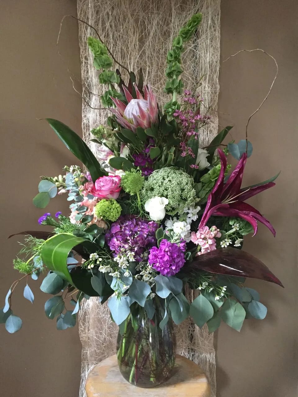 Purple and Green Bouquet - Arrangement with assorted purple and green blooms. (One side look)